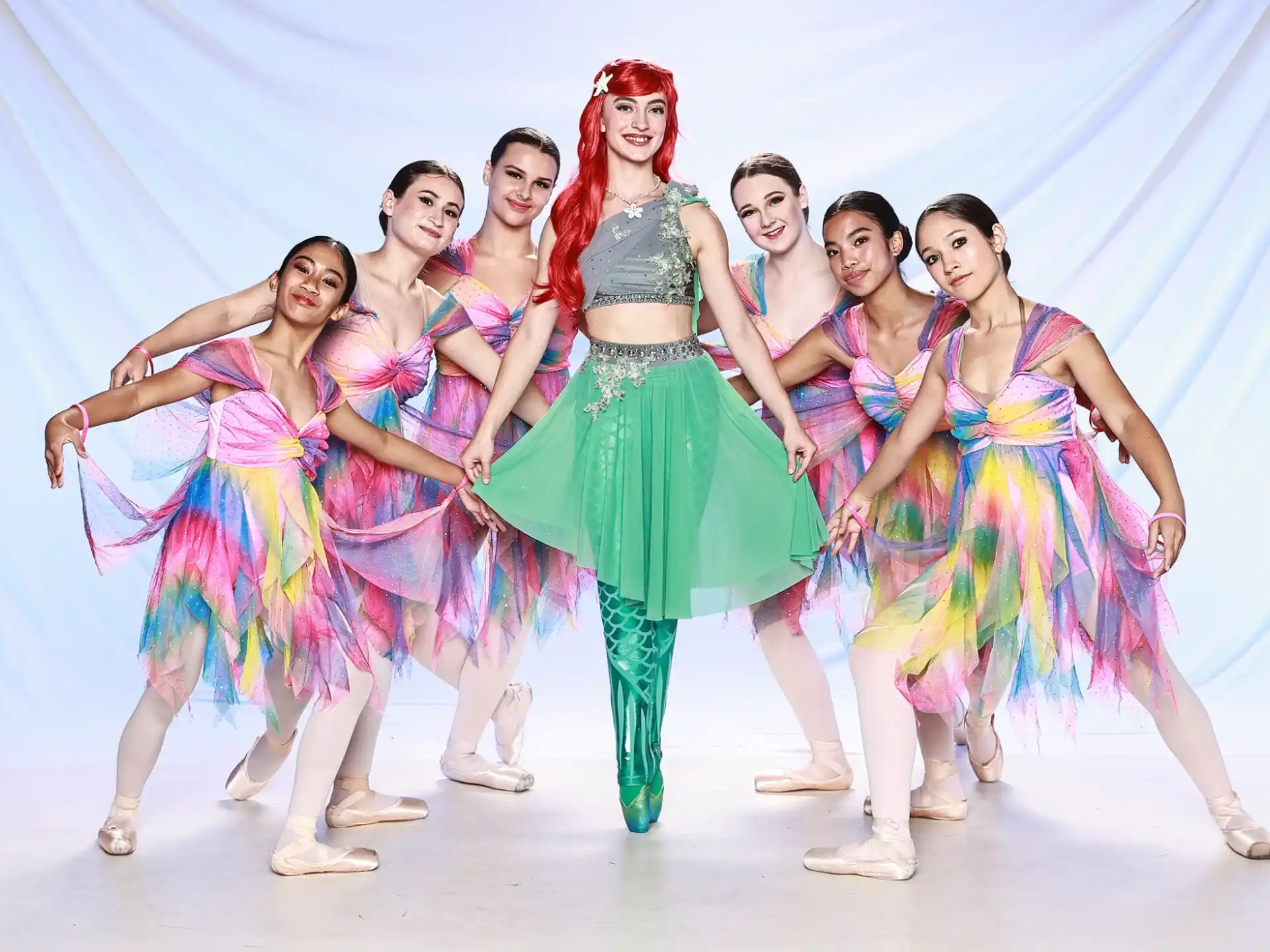 a group of women in colorful dresses