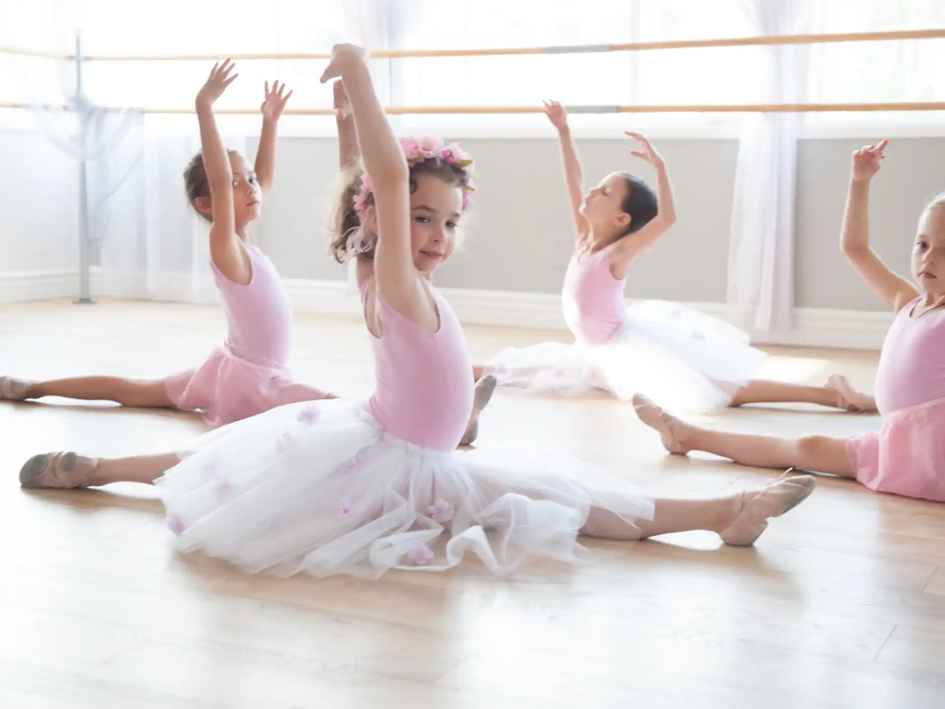 a group of girls in dresses dancing