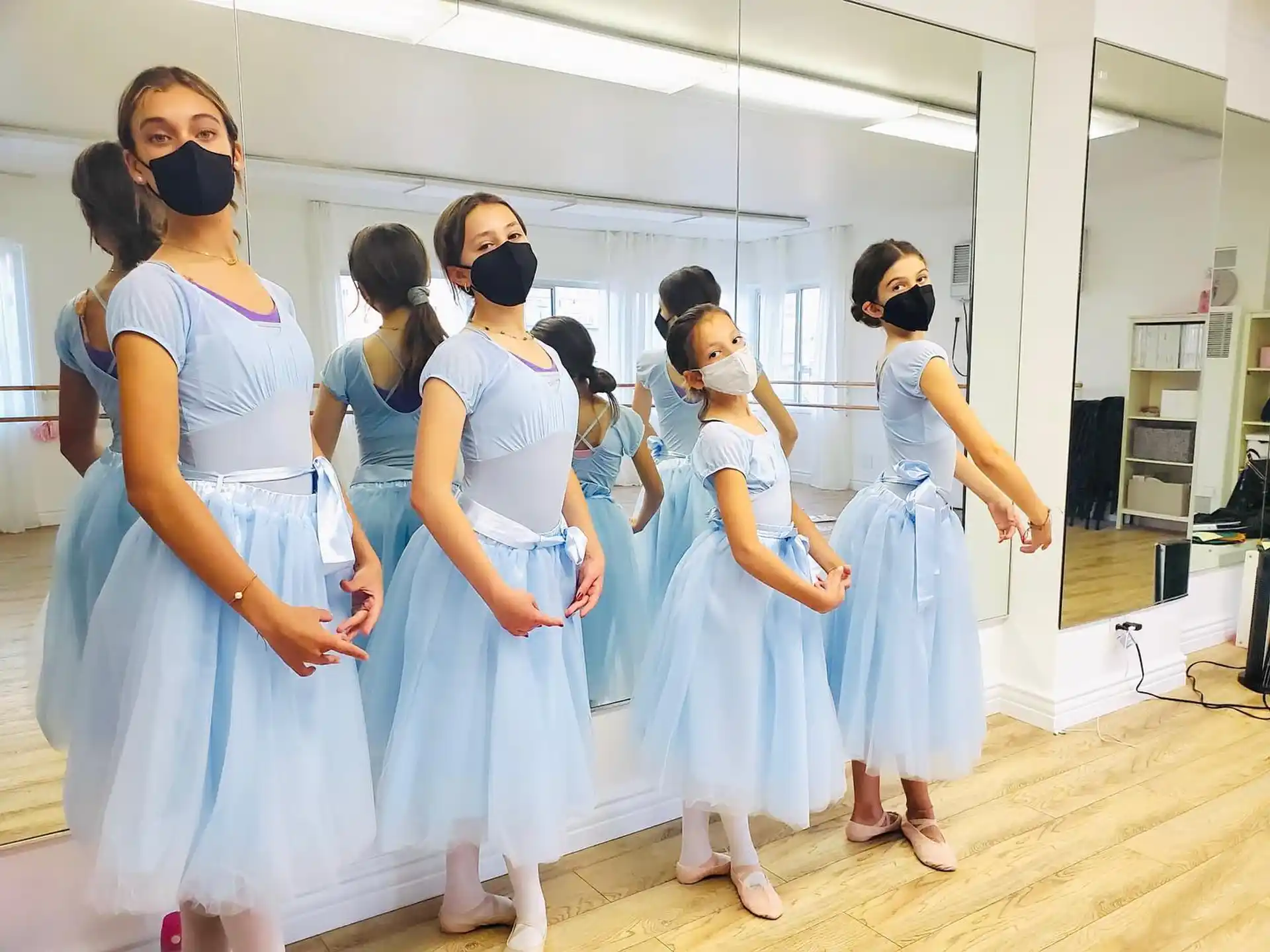 a group of women in blue dresses