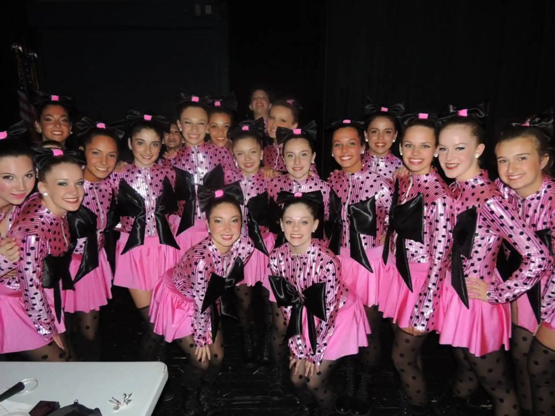 a group of girls in matching outfits