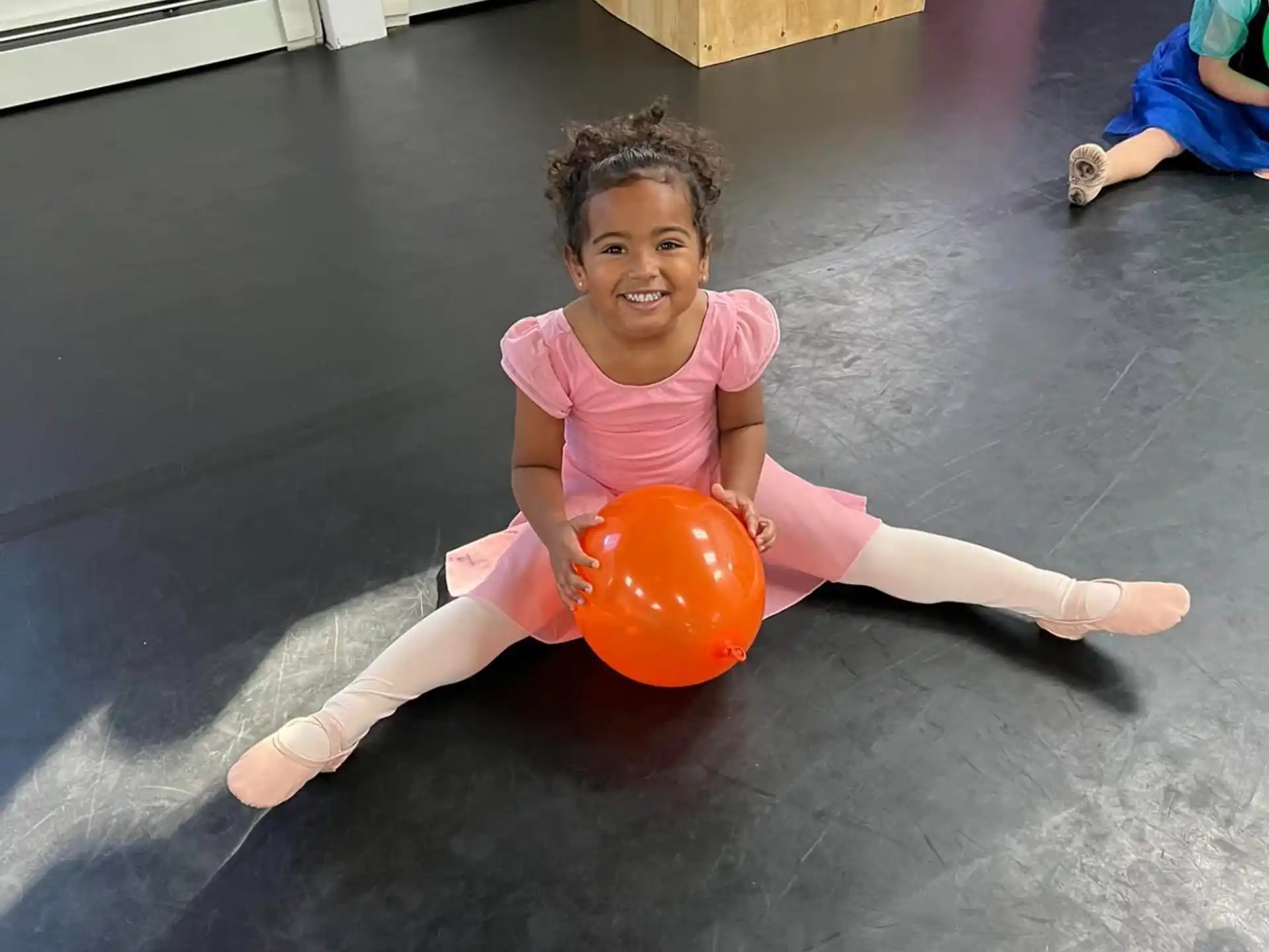 a girl sitting on a ball