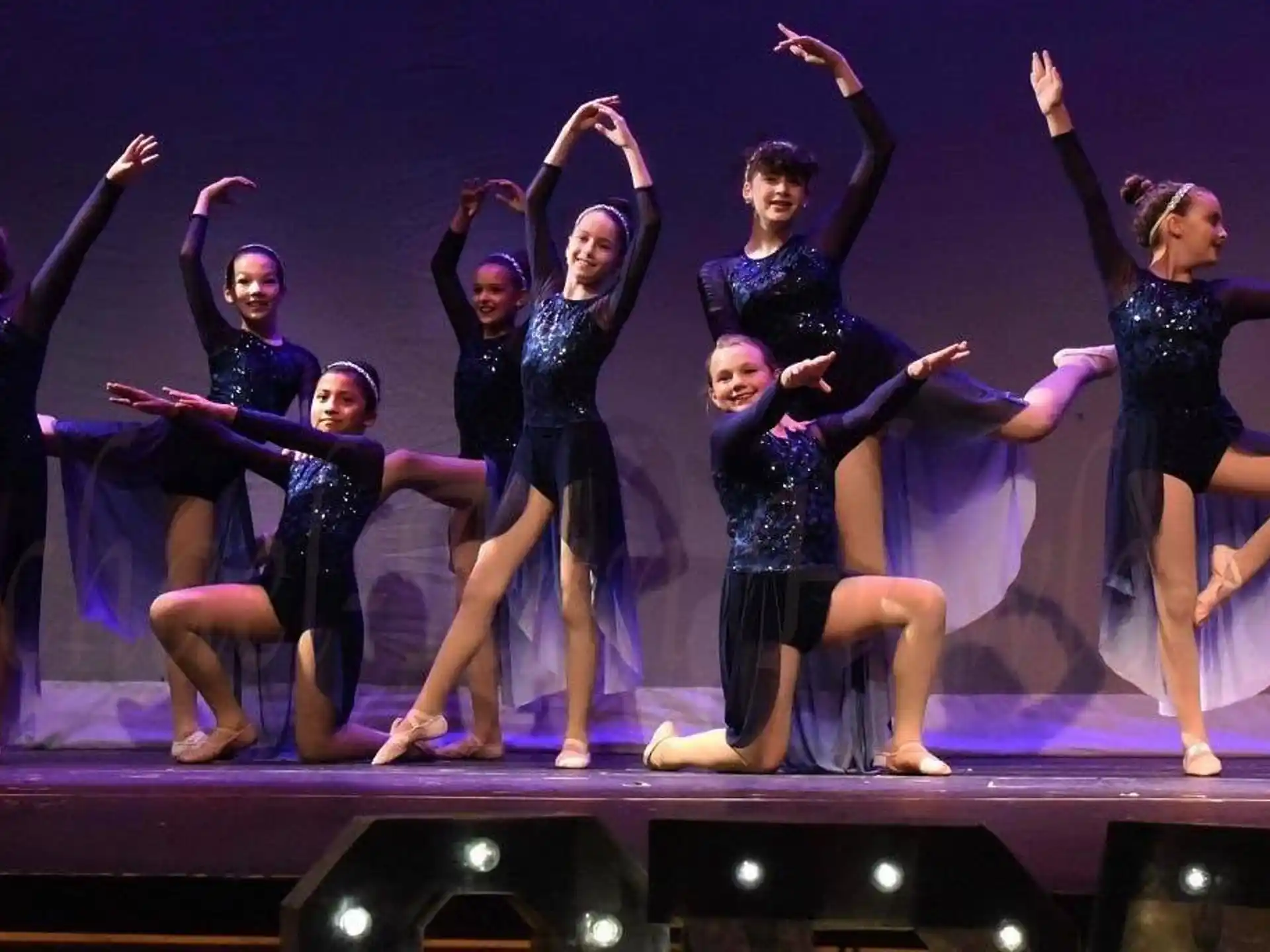 a group of women dancing on a stage
