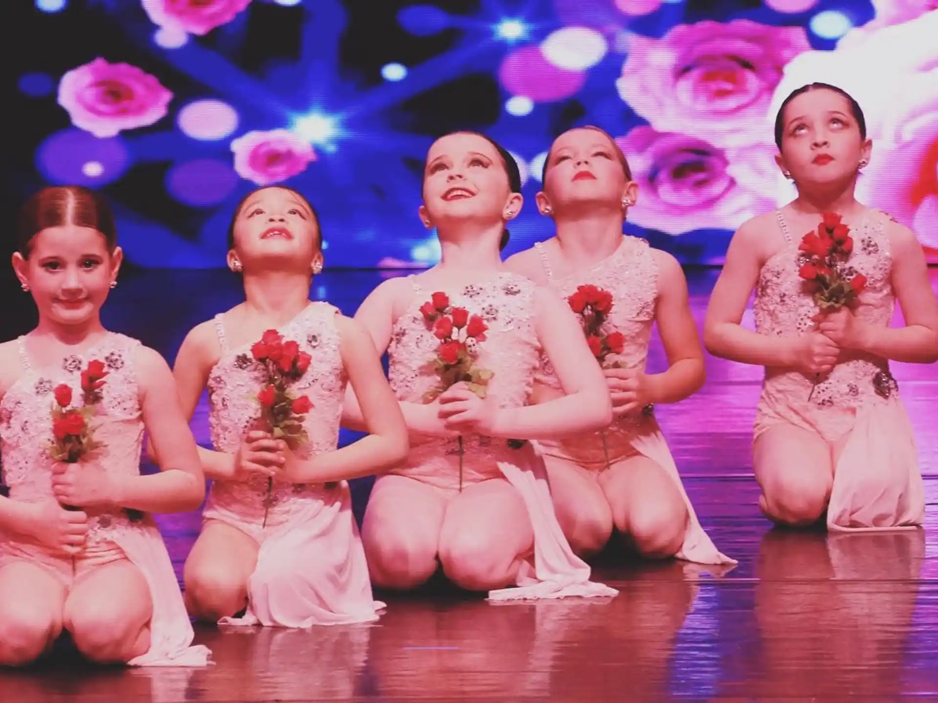 a group of women in pink dresses