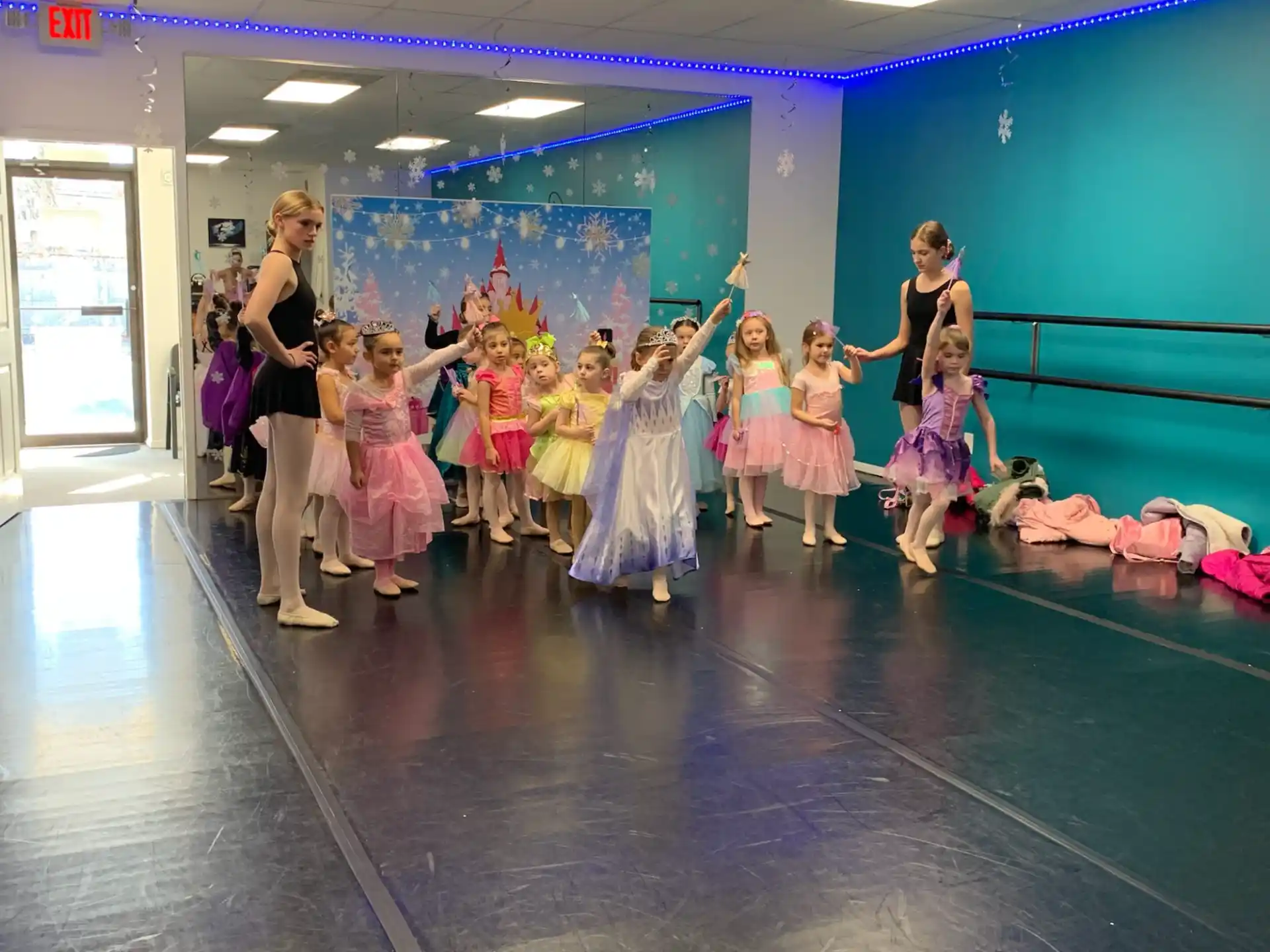 a group of women in dresses and dresses dancing on a stage