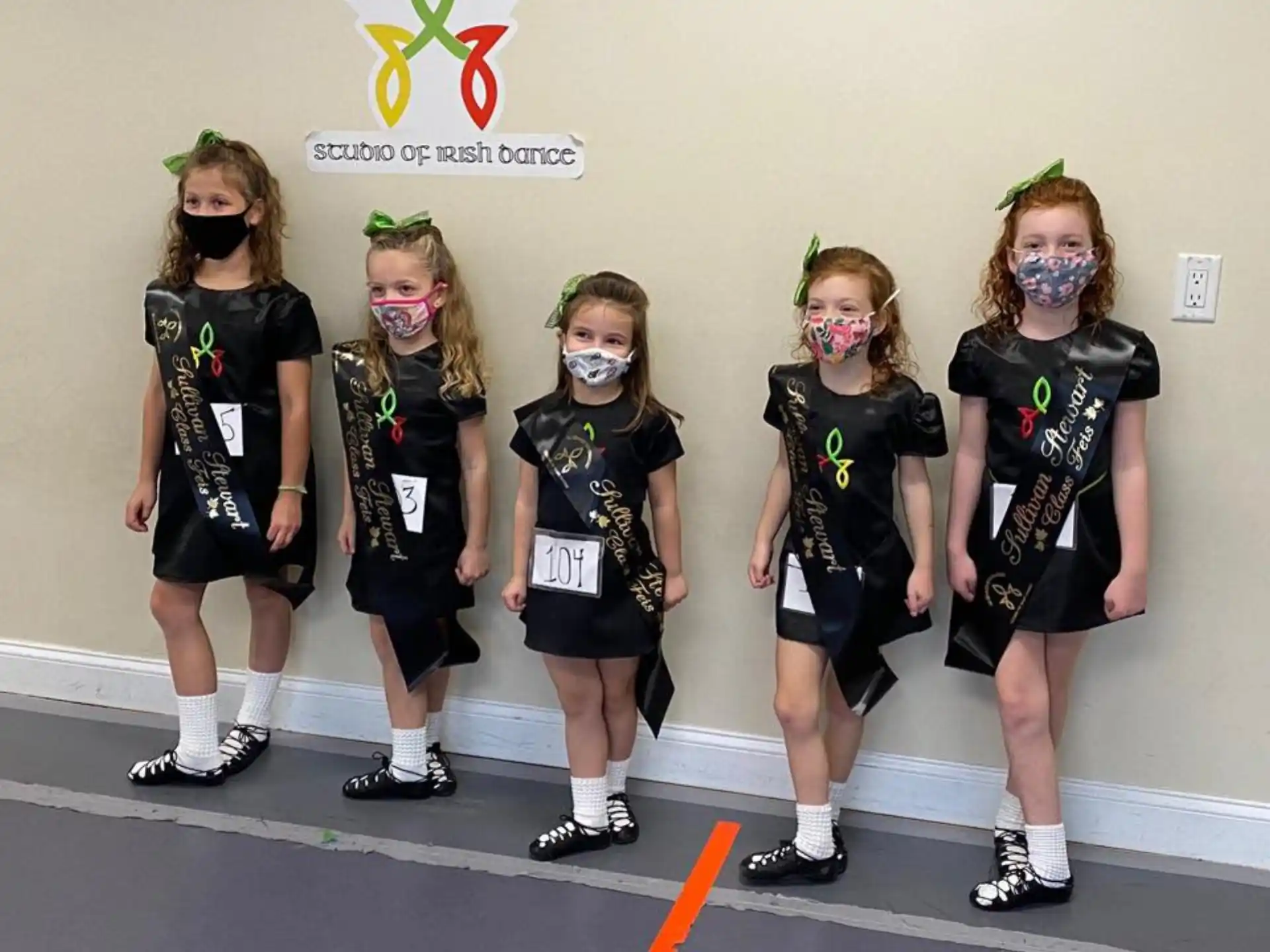 a group of girls wearing face masks