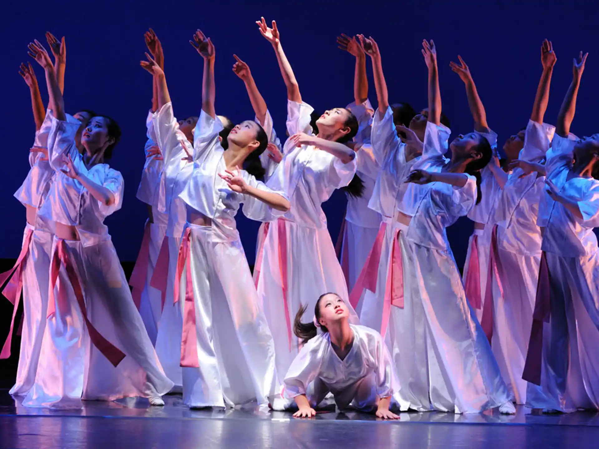 a group of women in white dresses