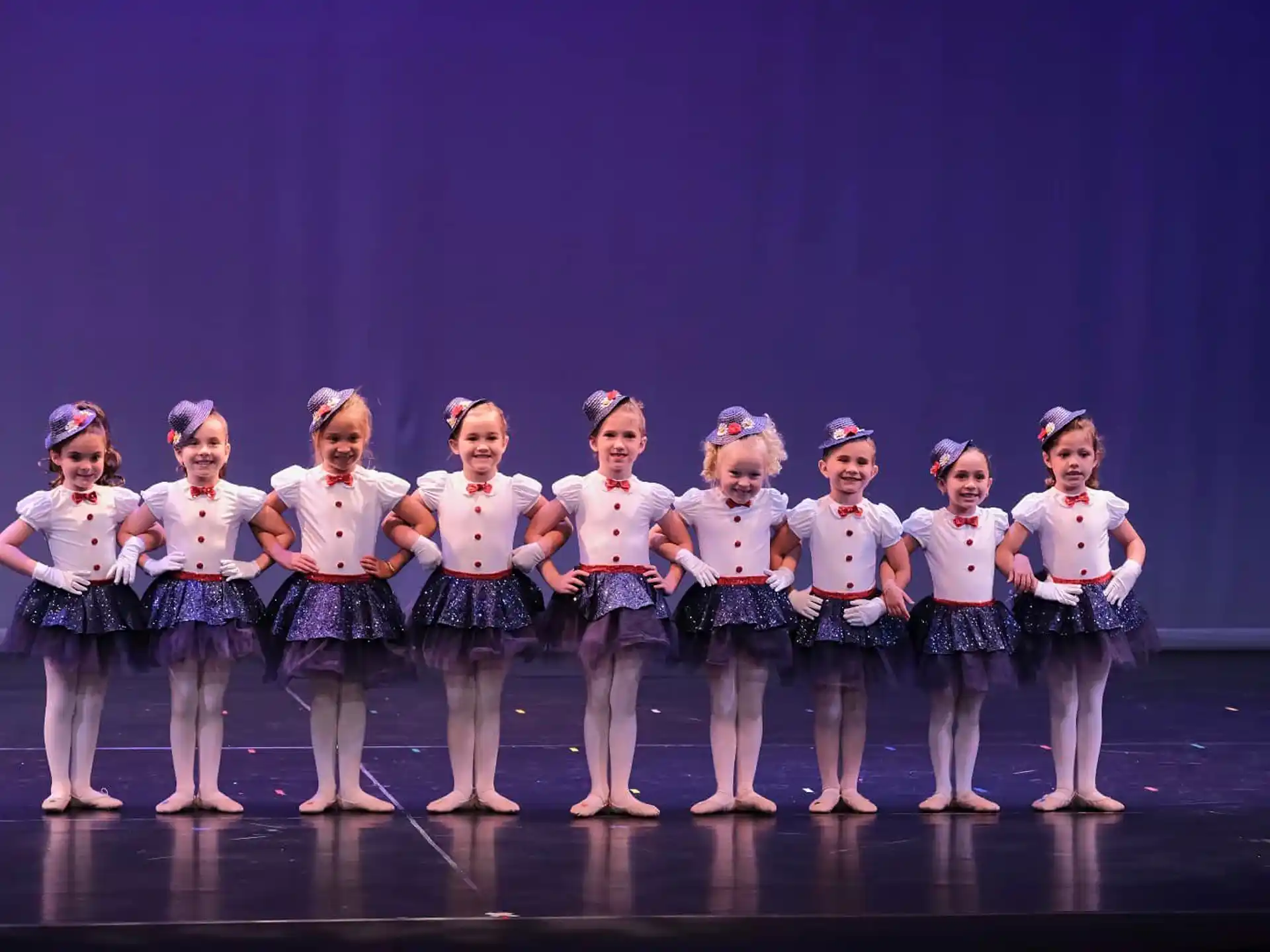 a group of girls in matching outfits