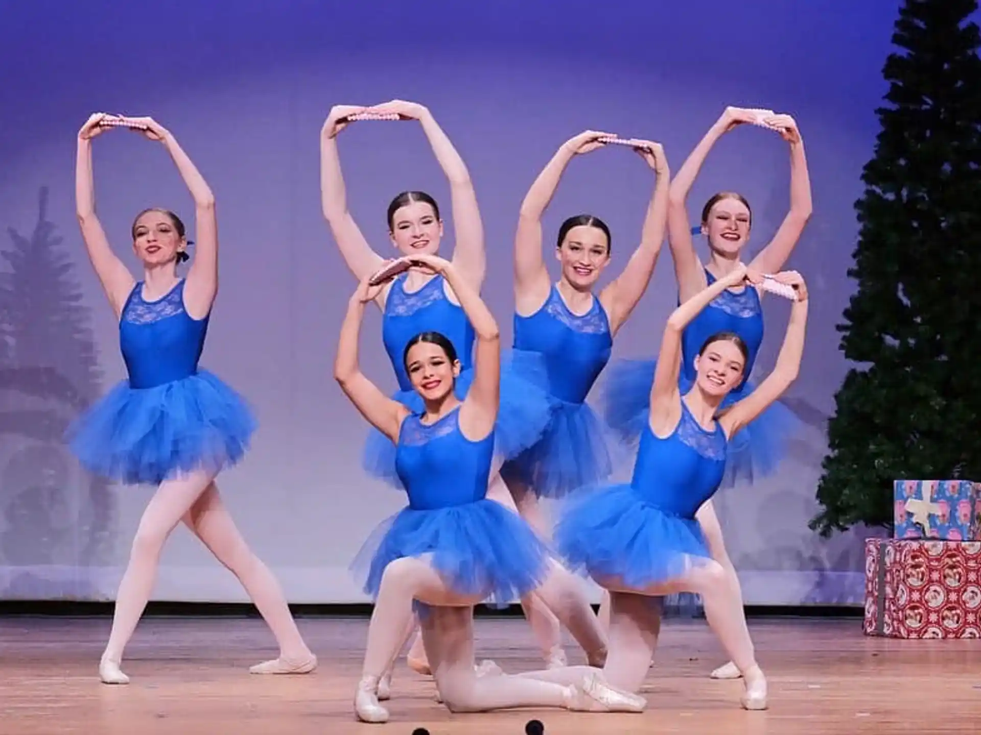 a group of women in blue dresses
