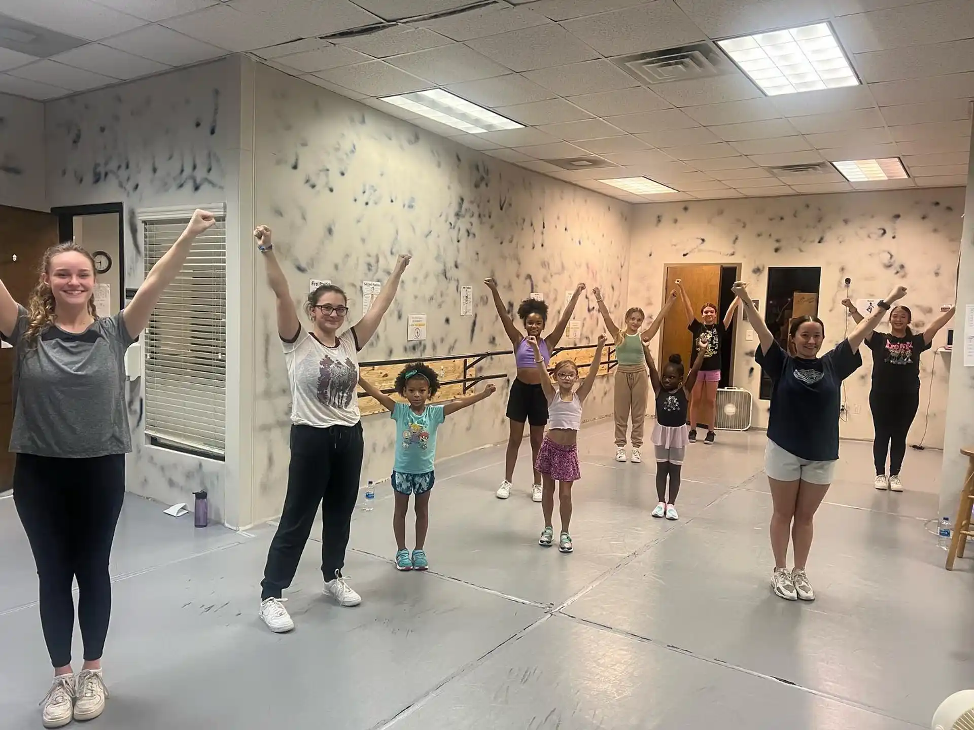 a group of people exercising in a room