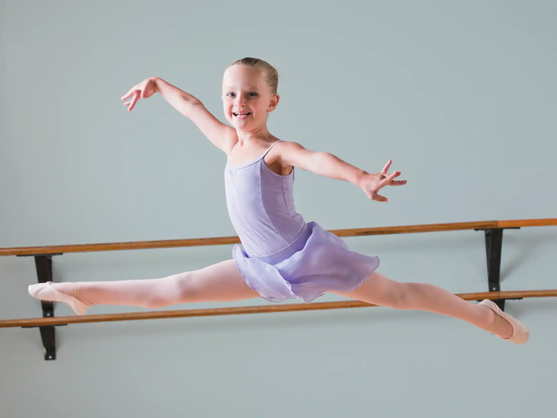 a person in a leotard doing a plank on a wood plank