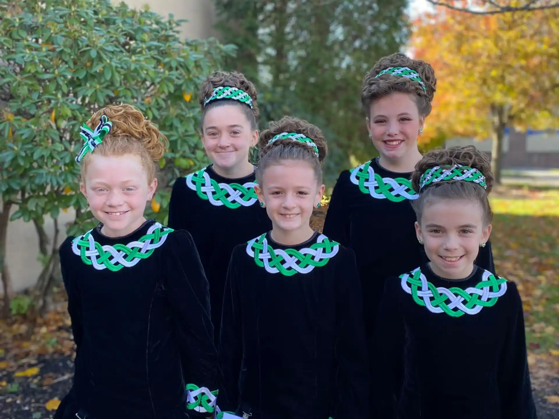 a group of girls in black and white uniforms