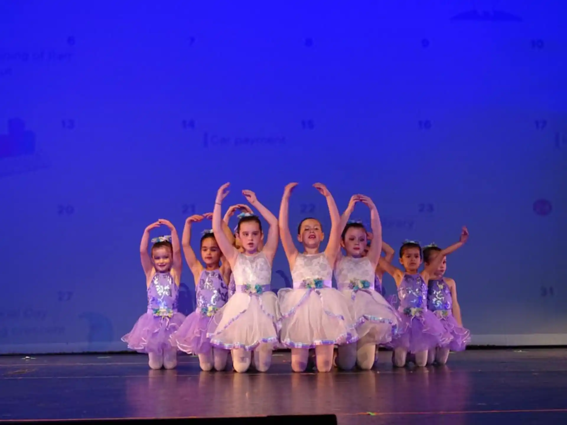 a group of girls in white dresses