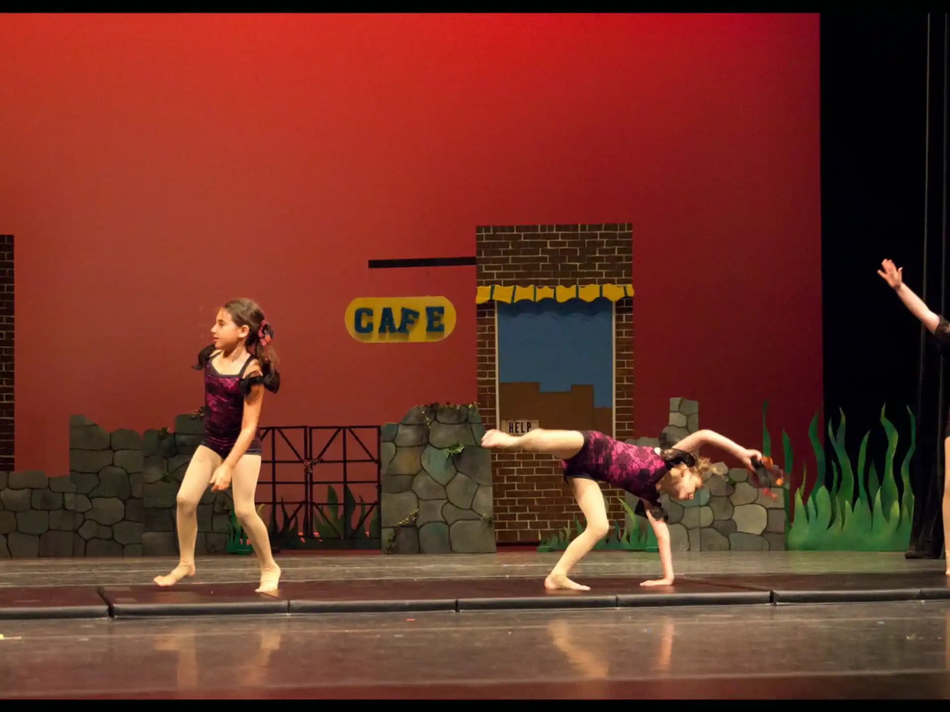 a group of girls dancing on a stage