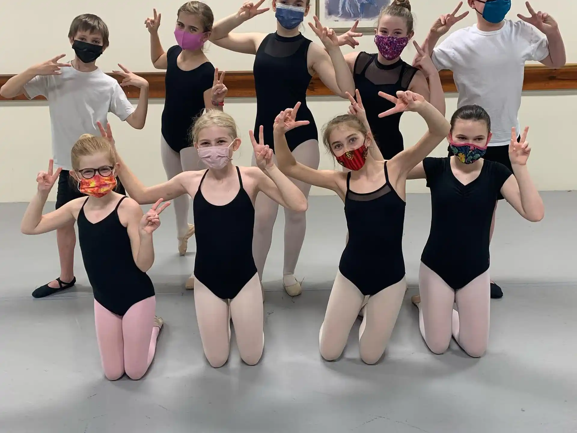 a group of people wearing masks and posing for the camera