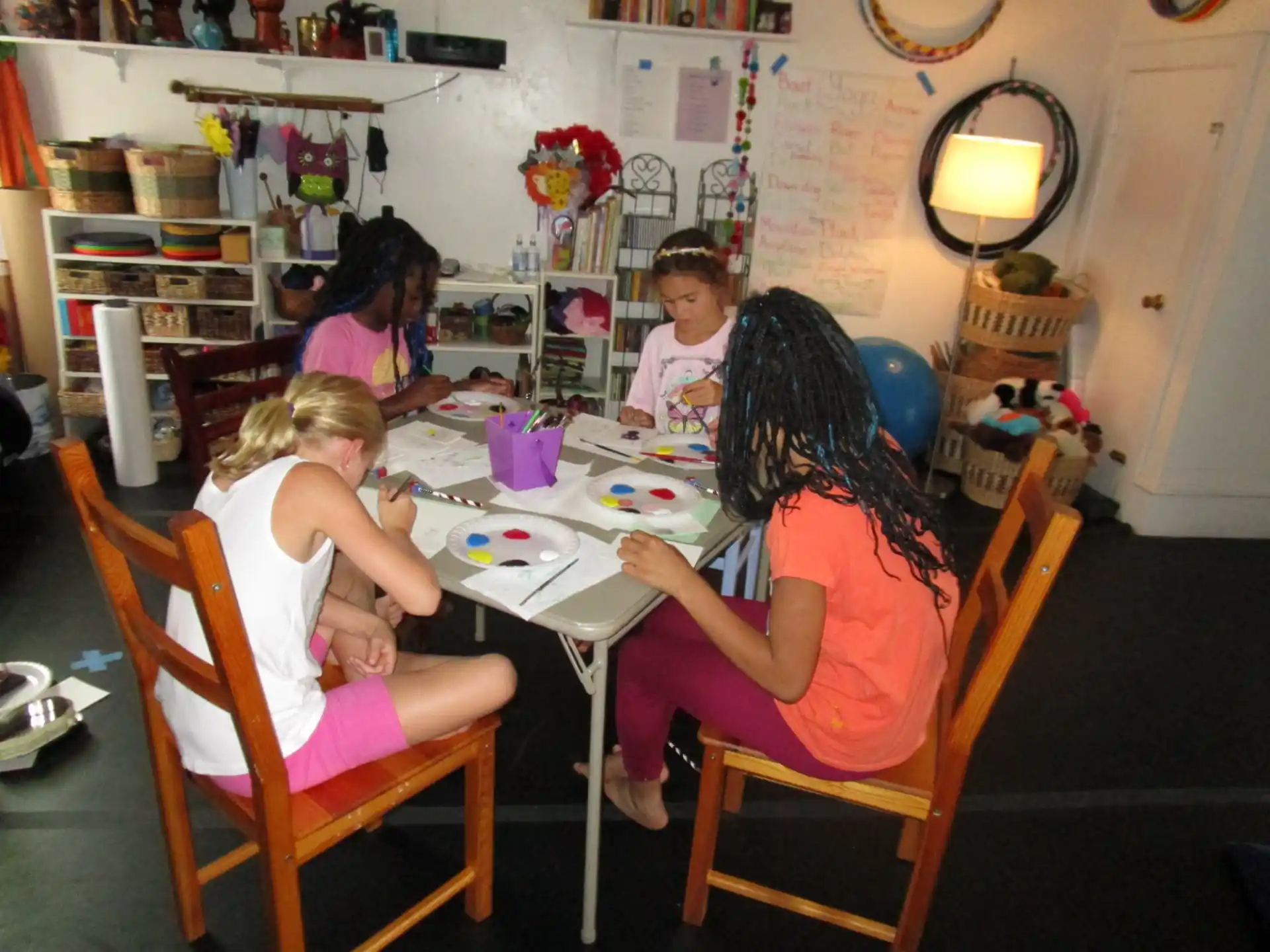 a group of children sitting around a table