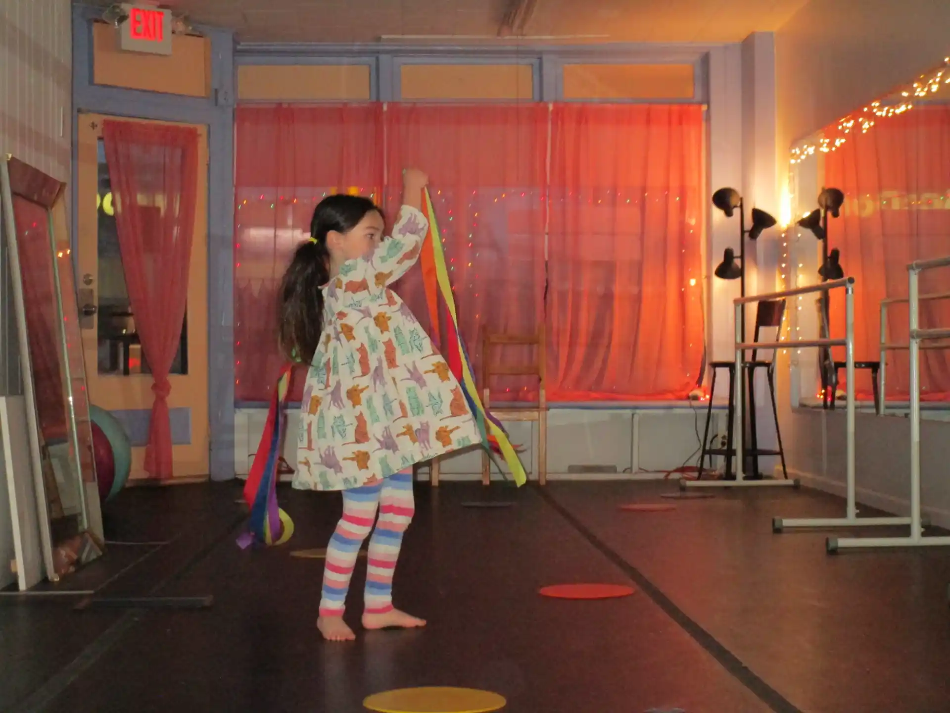 a person in a colorful dress holding a broom and a broom