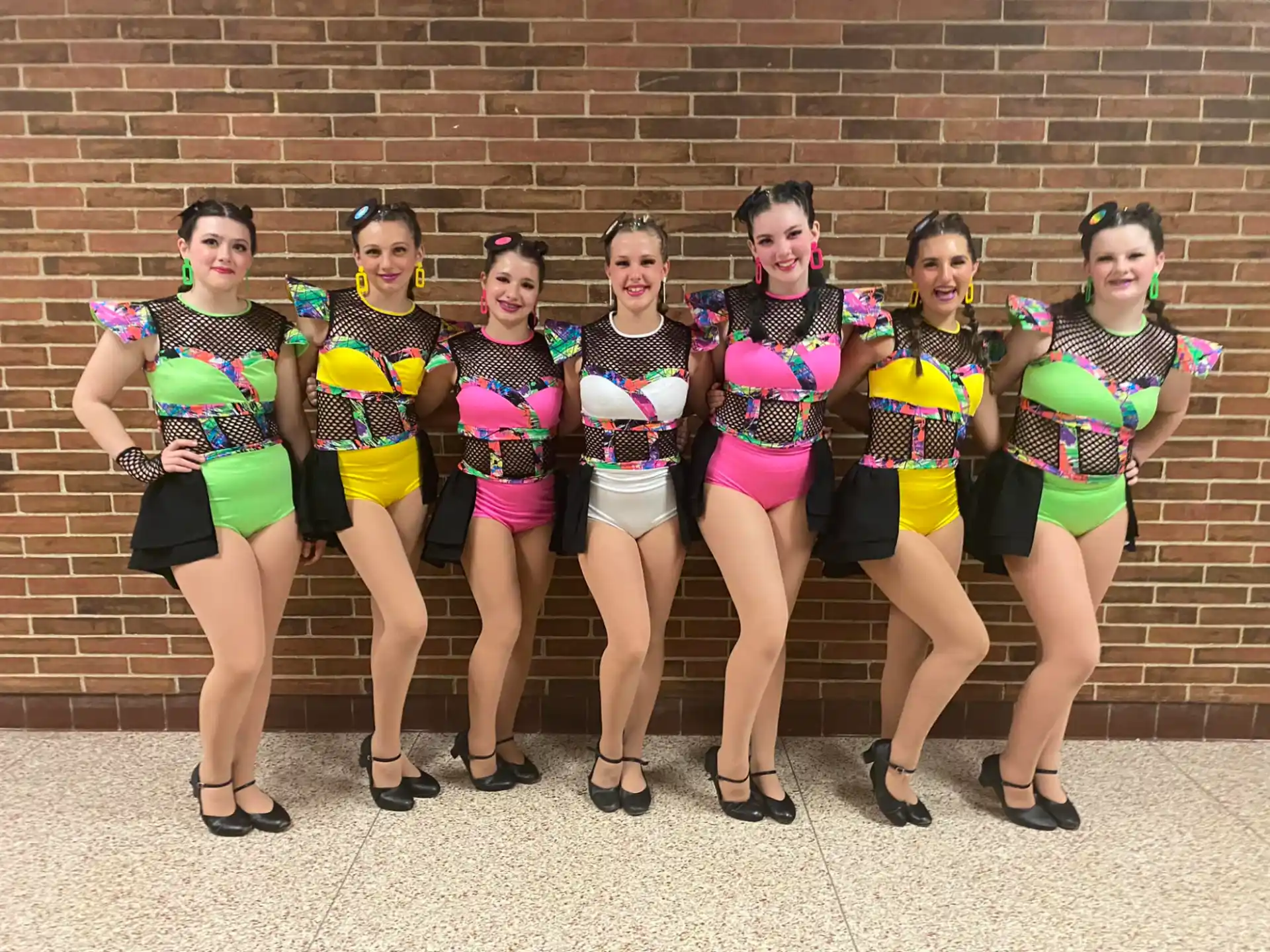 a group of women in matching outfits