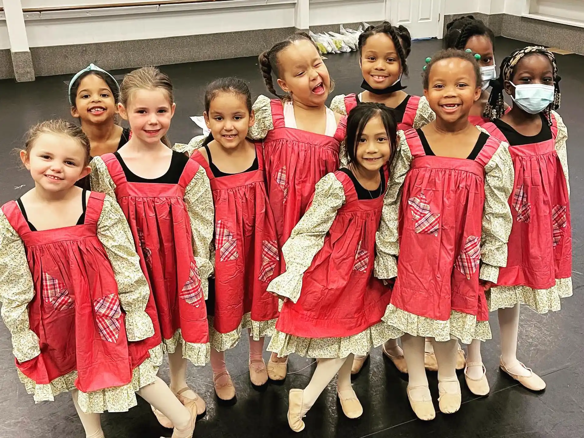 a group of girls in red and white dresses