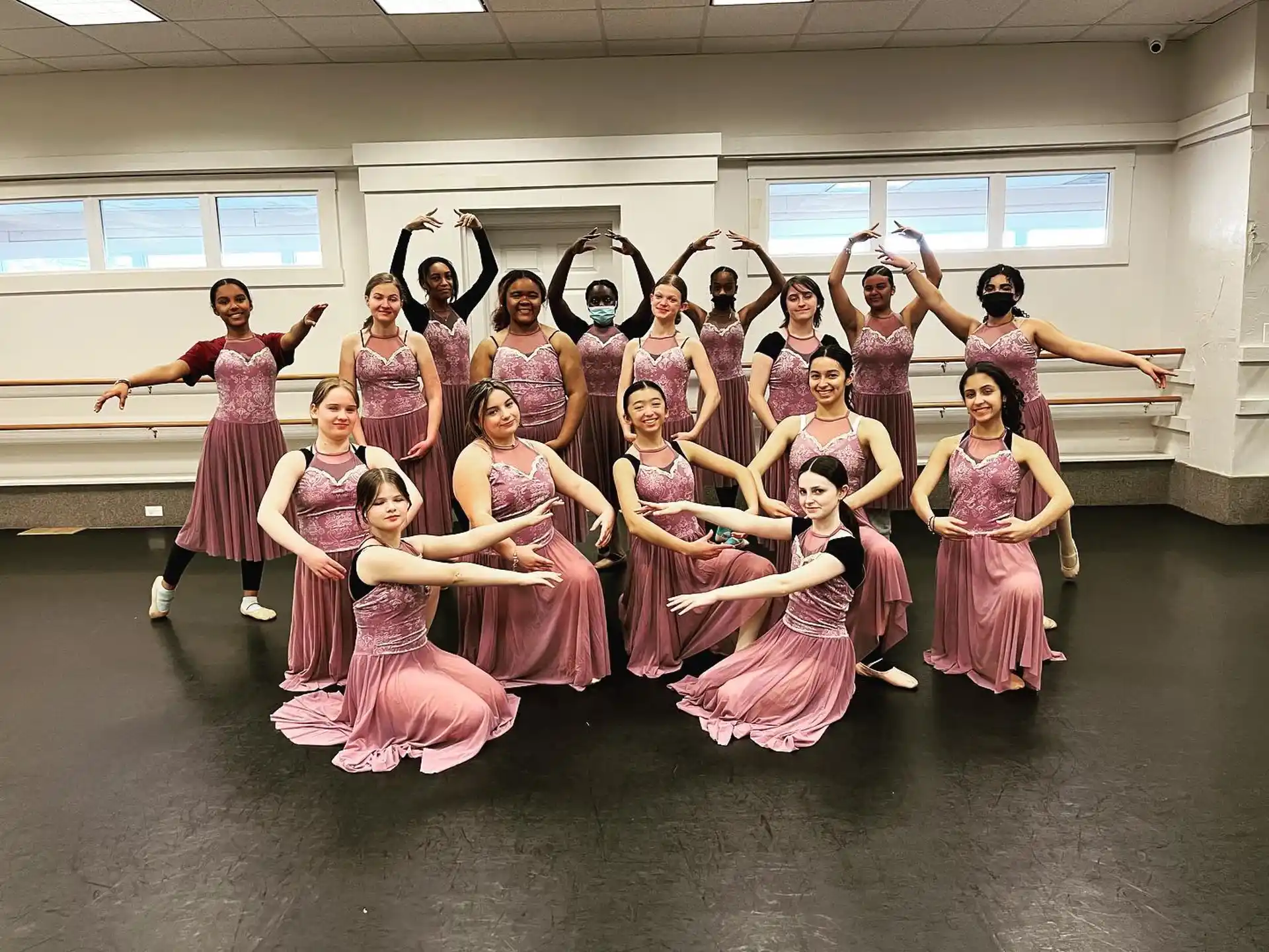a group of women in dresses posing for a photo