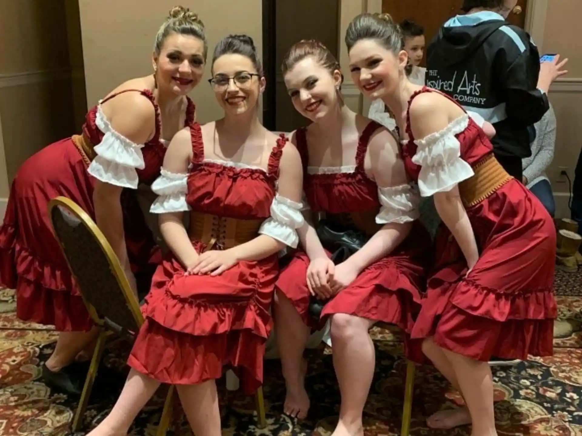 a group of women sitting on chairs