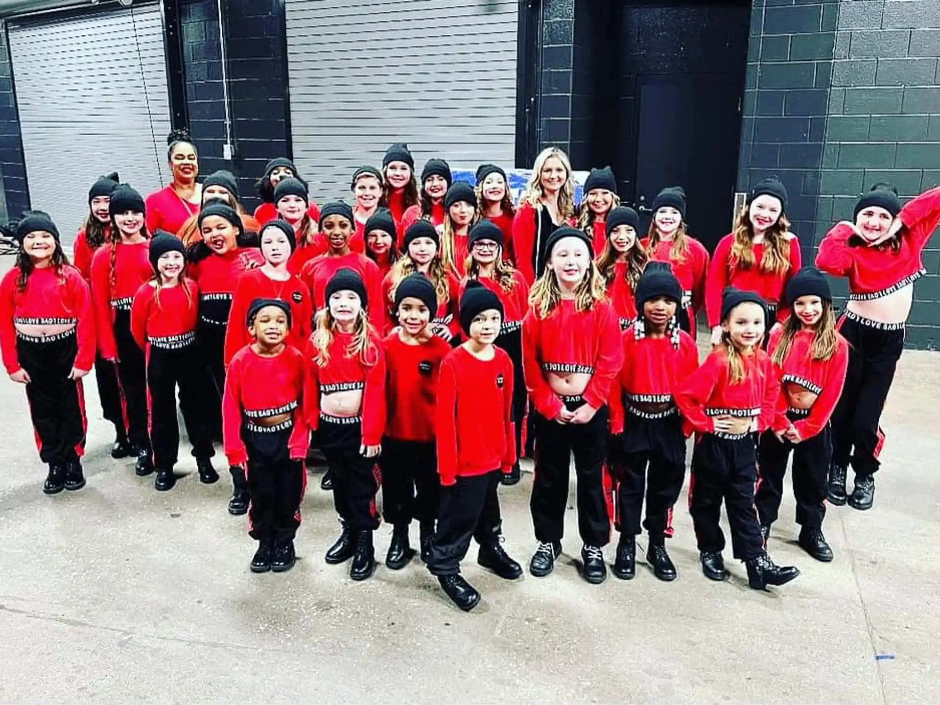 a group of people in red and black uniforms posing for a photo