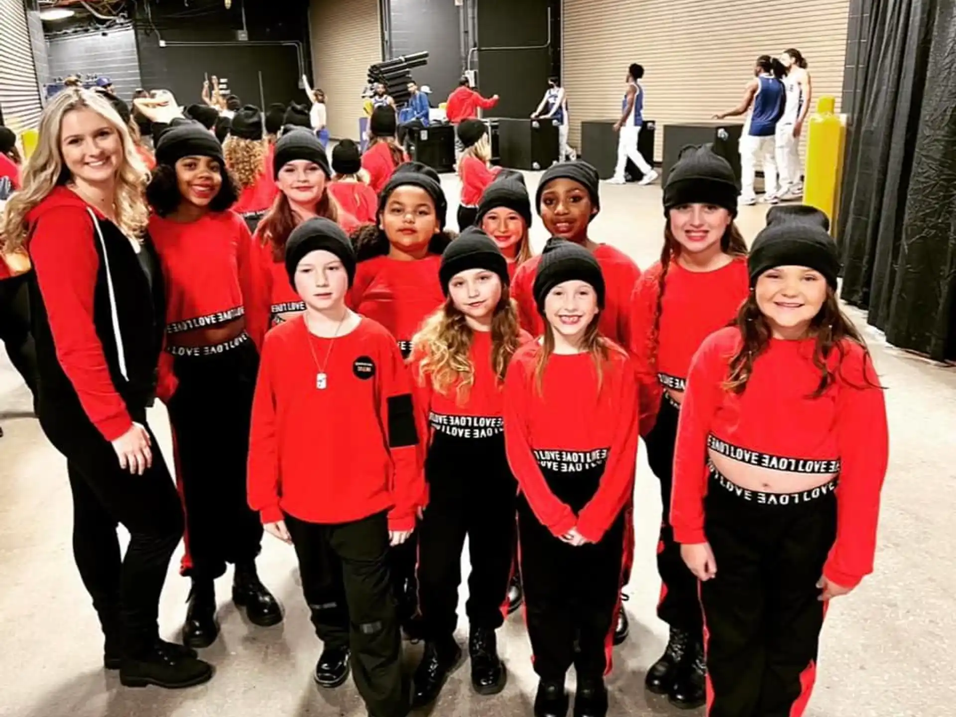 a group of people in red and black uniforms posing for the camera