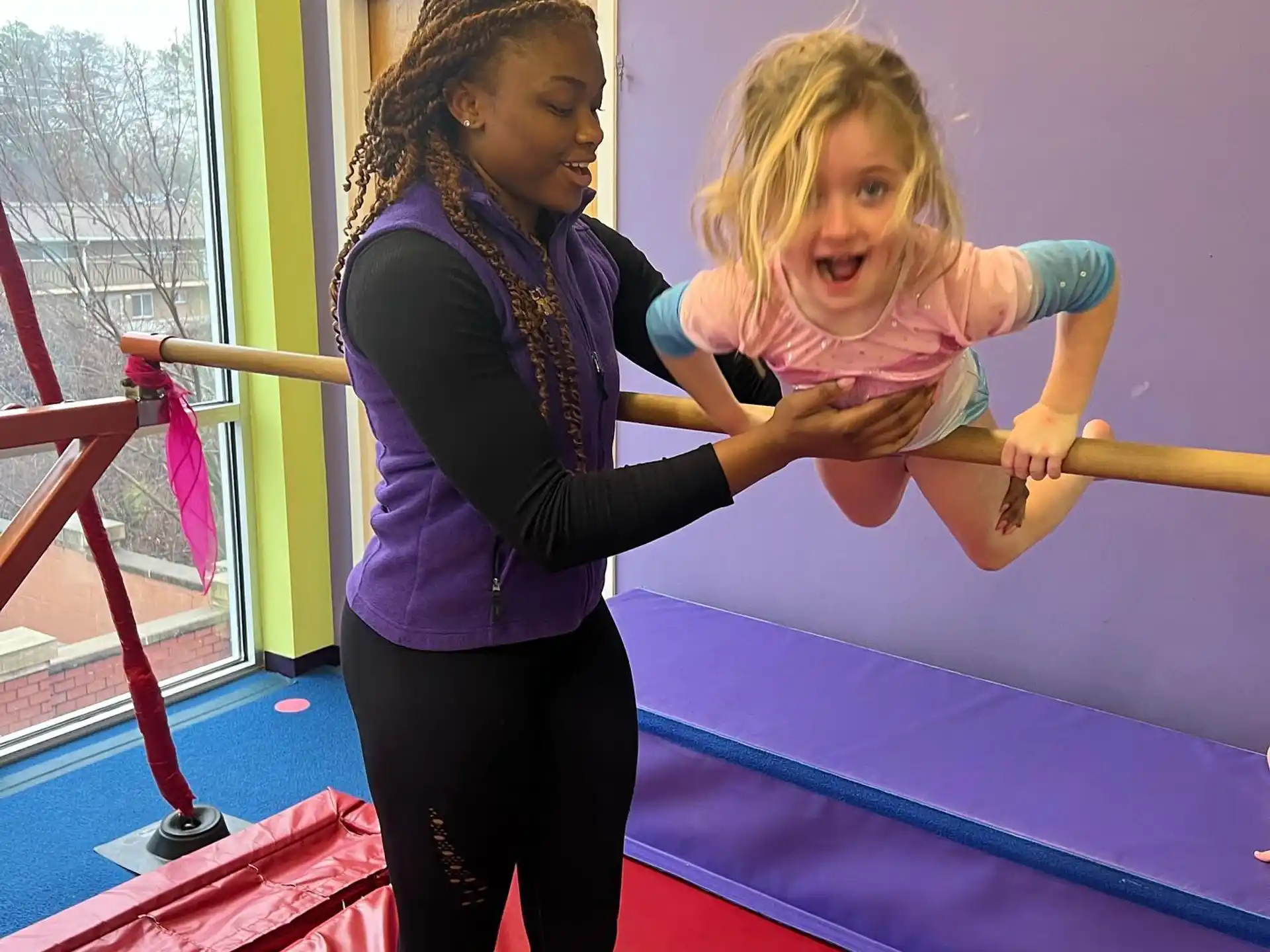 a person holding a girl on a bed