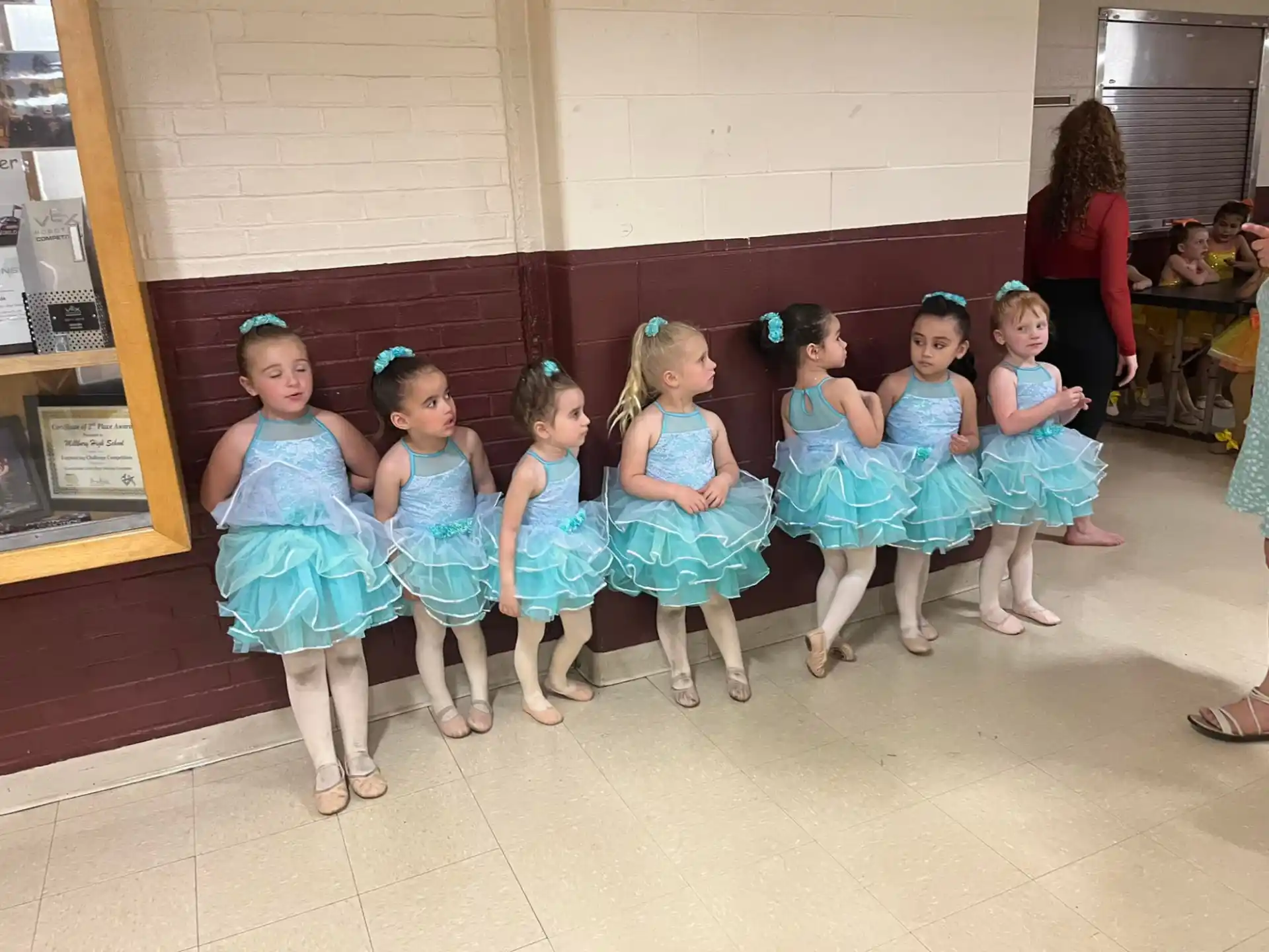 a group of girls in blue dresses