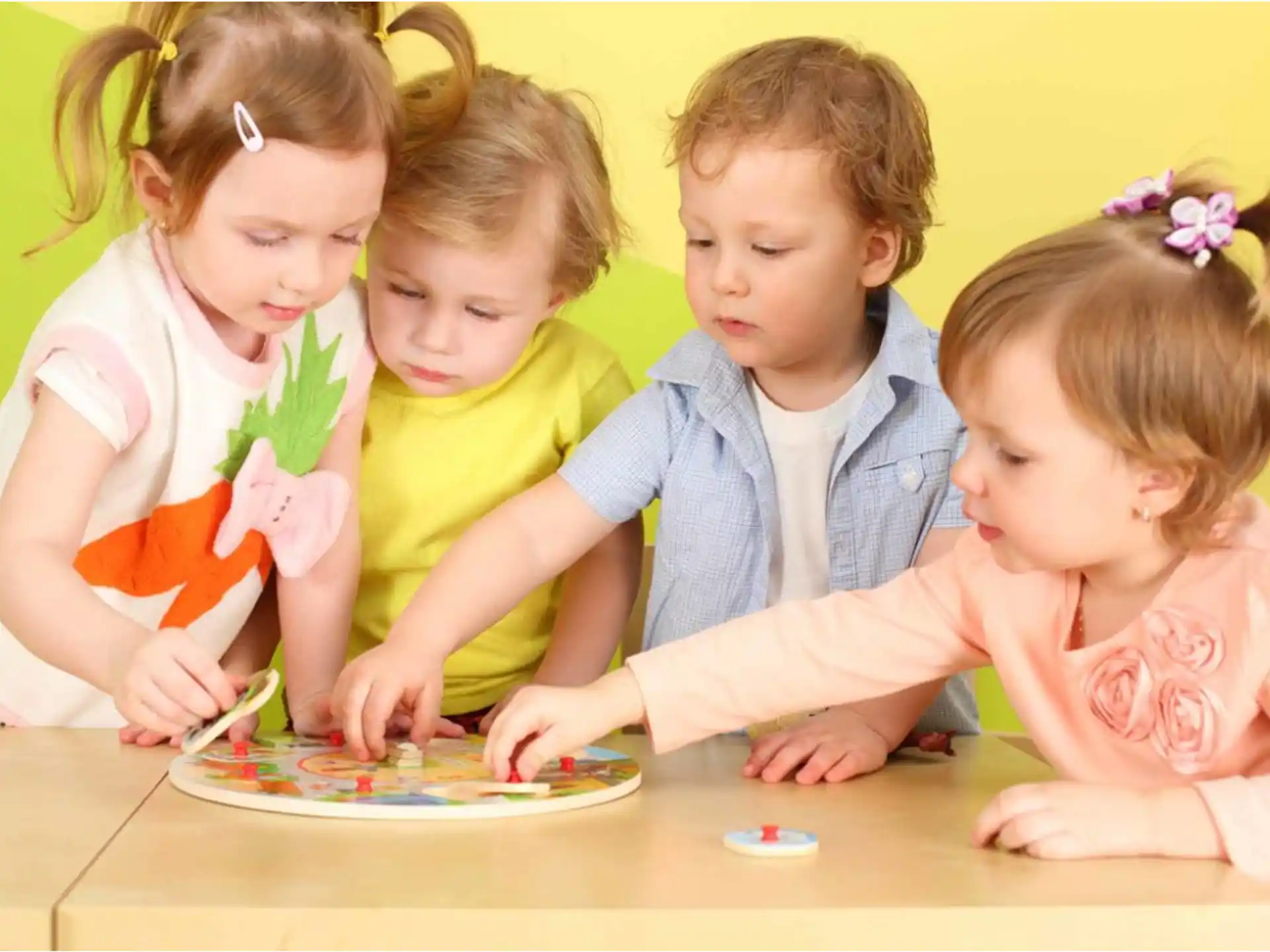 a group of children sitting at a table eating