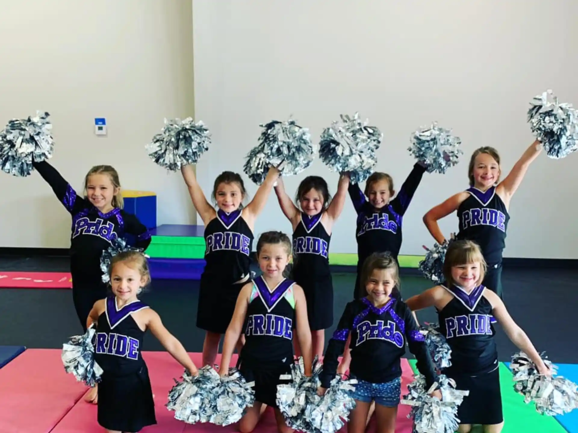 a group of cheerleaders holding up their hands