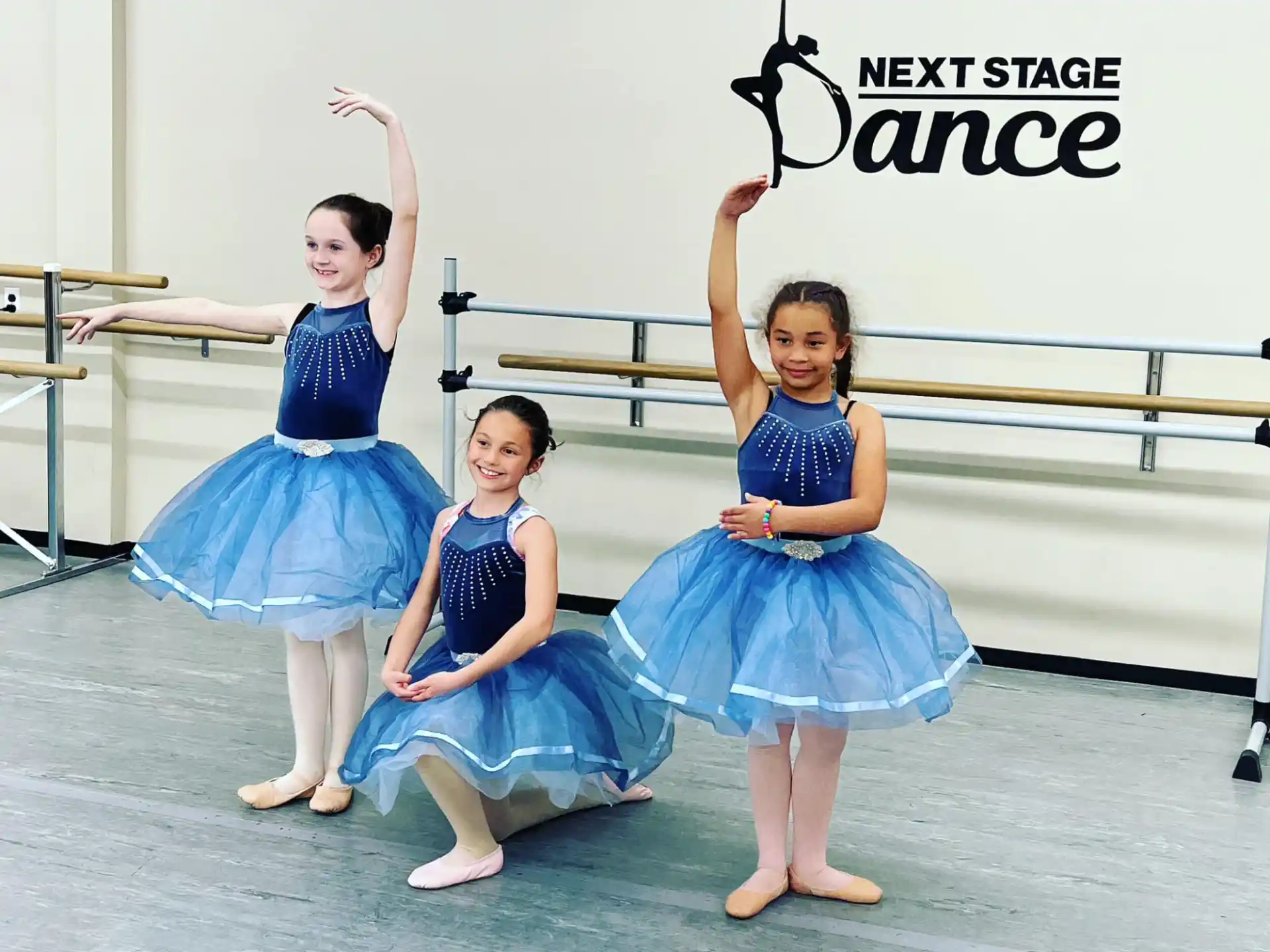 a group of girls in blue dresses