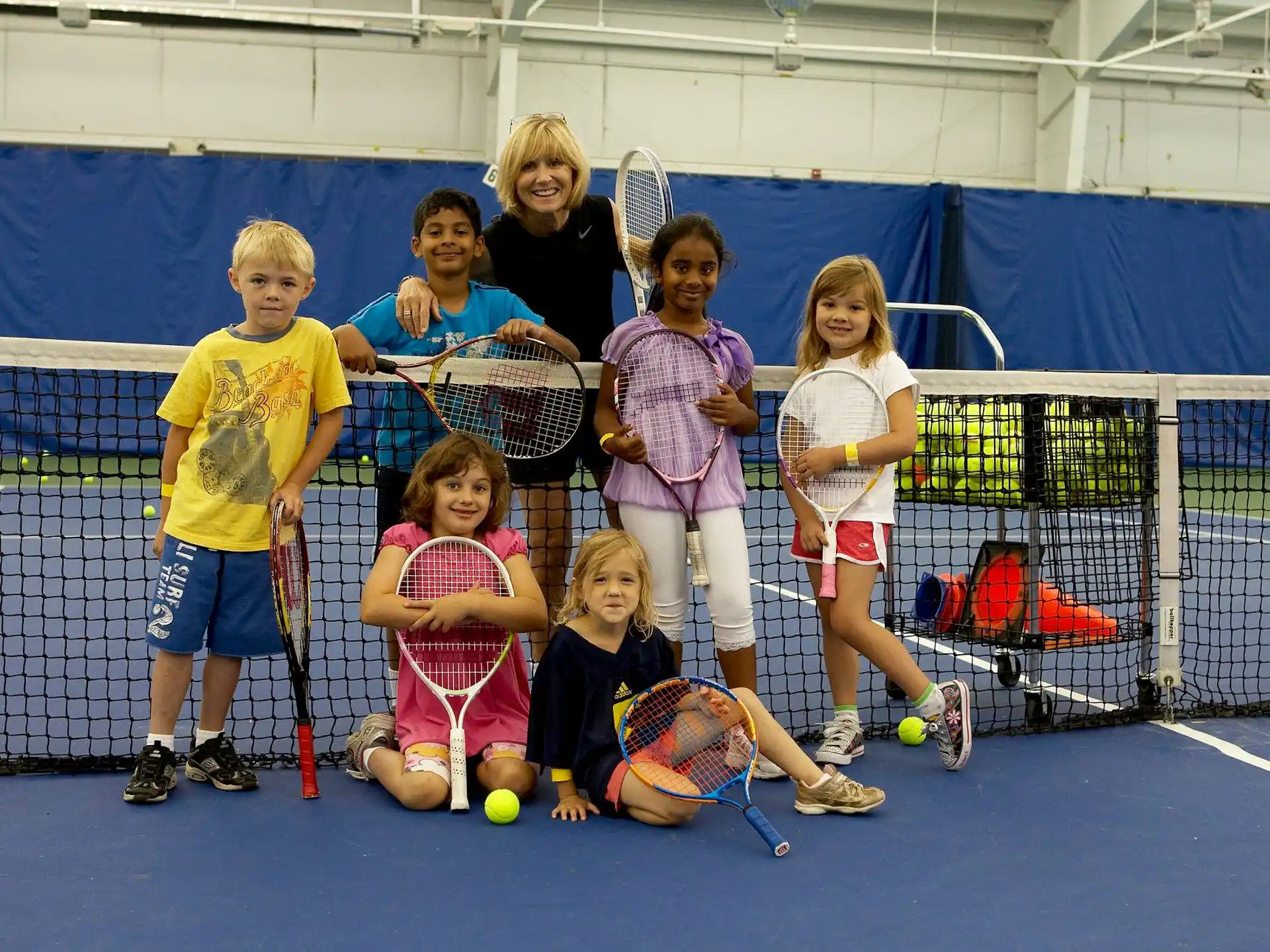kids holding tennis rackets
