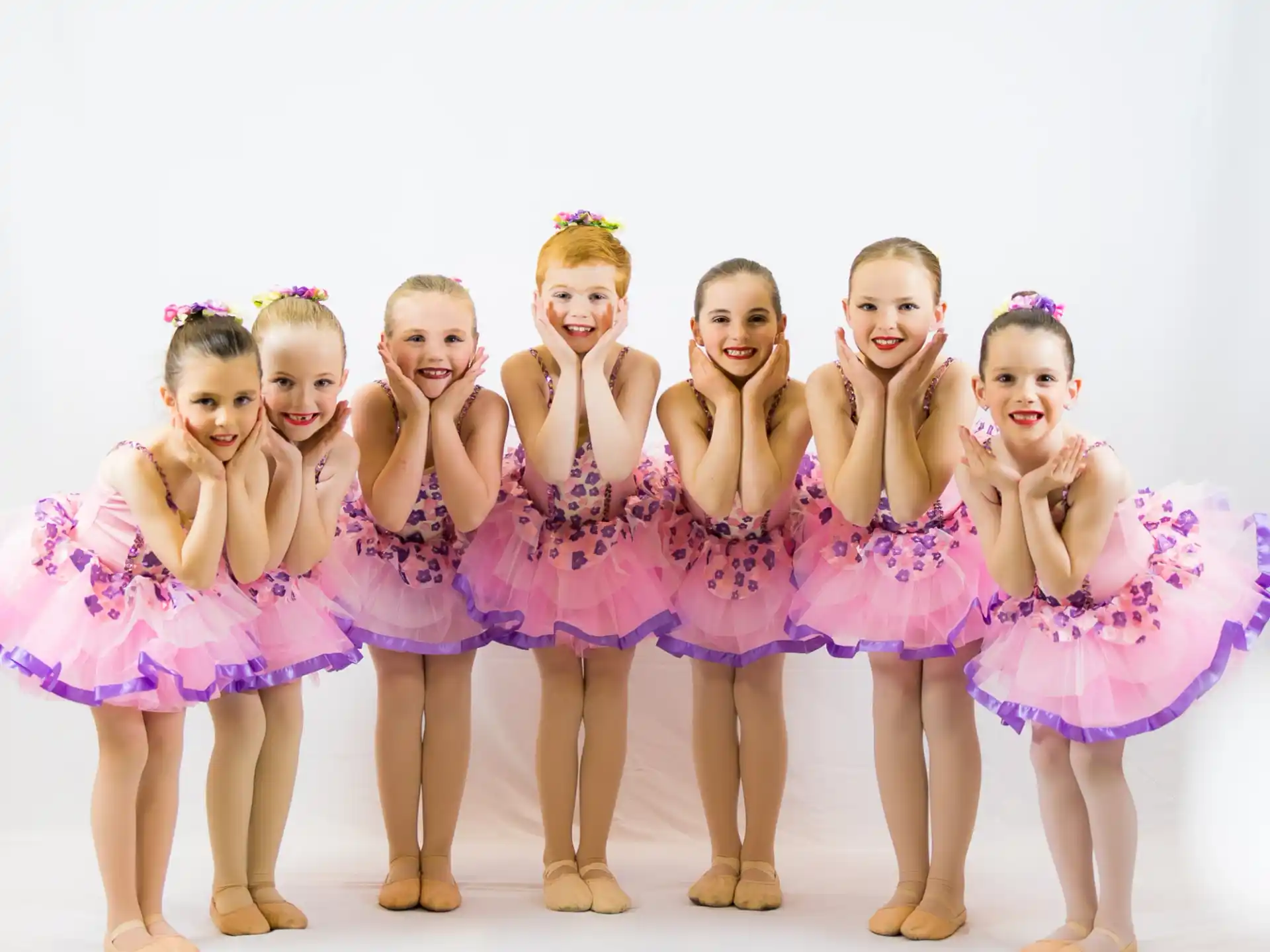 a group of girls in dresses