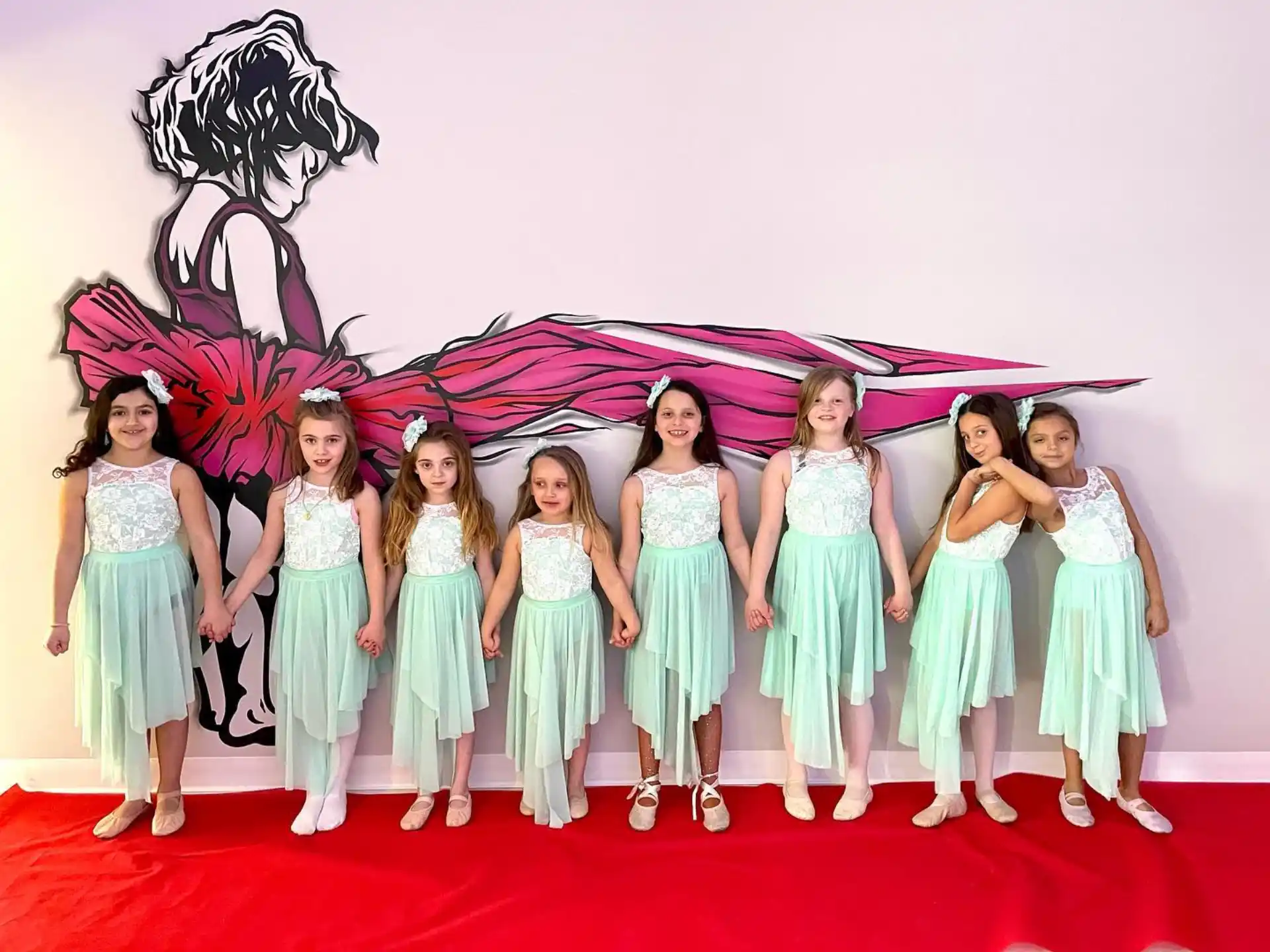 a group of girls in dresses