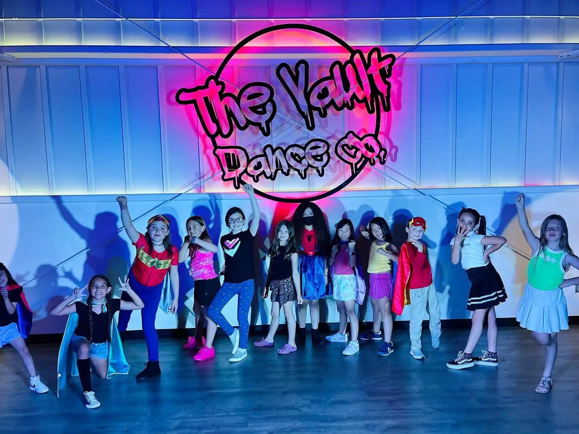 a group of people posing for a photo in front of a sign