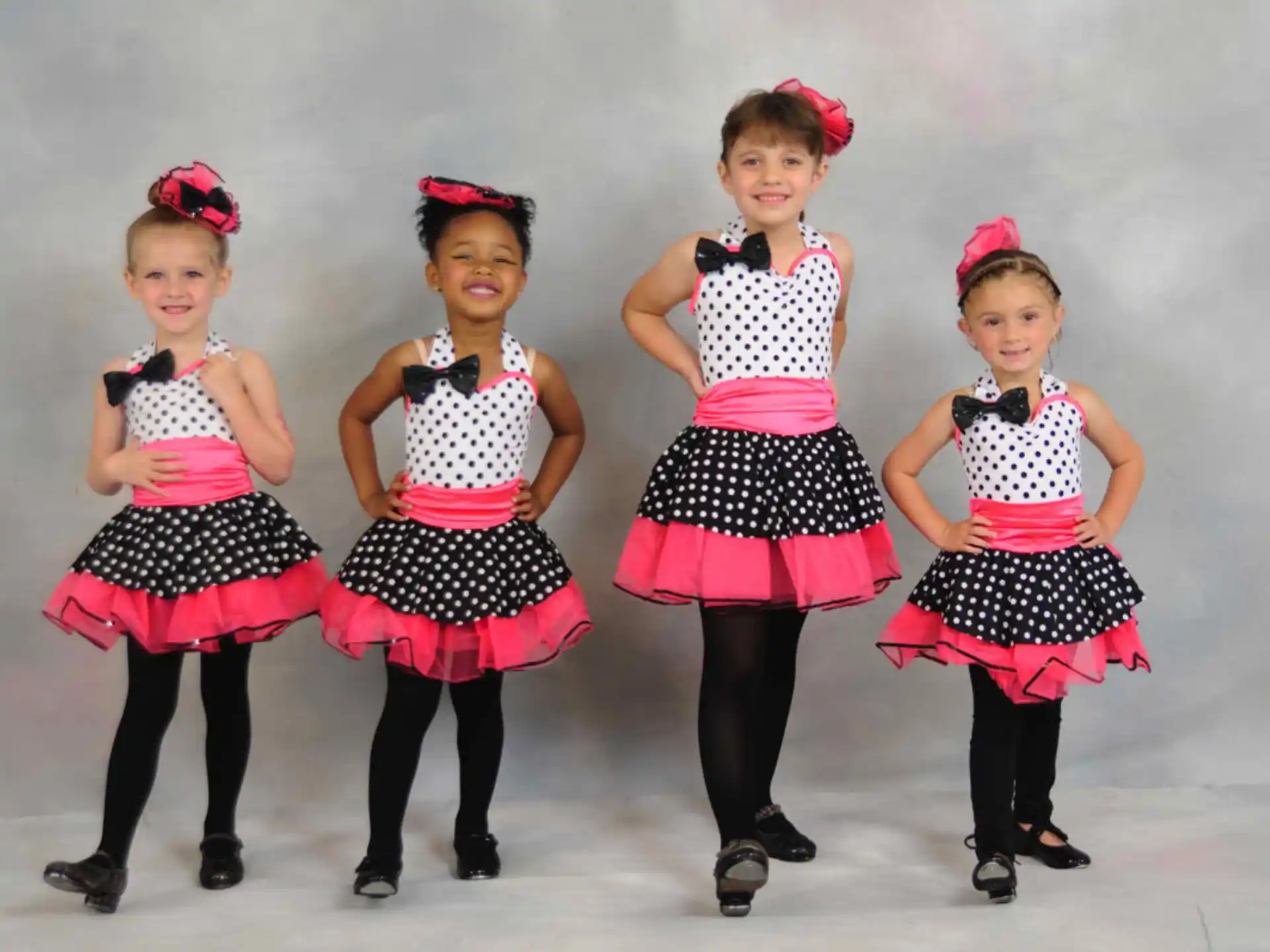 a group of girls in dresses