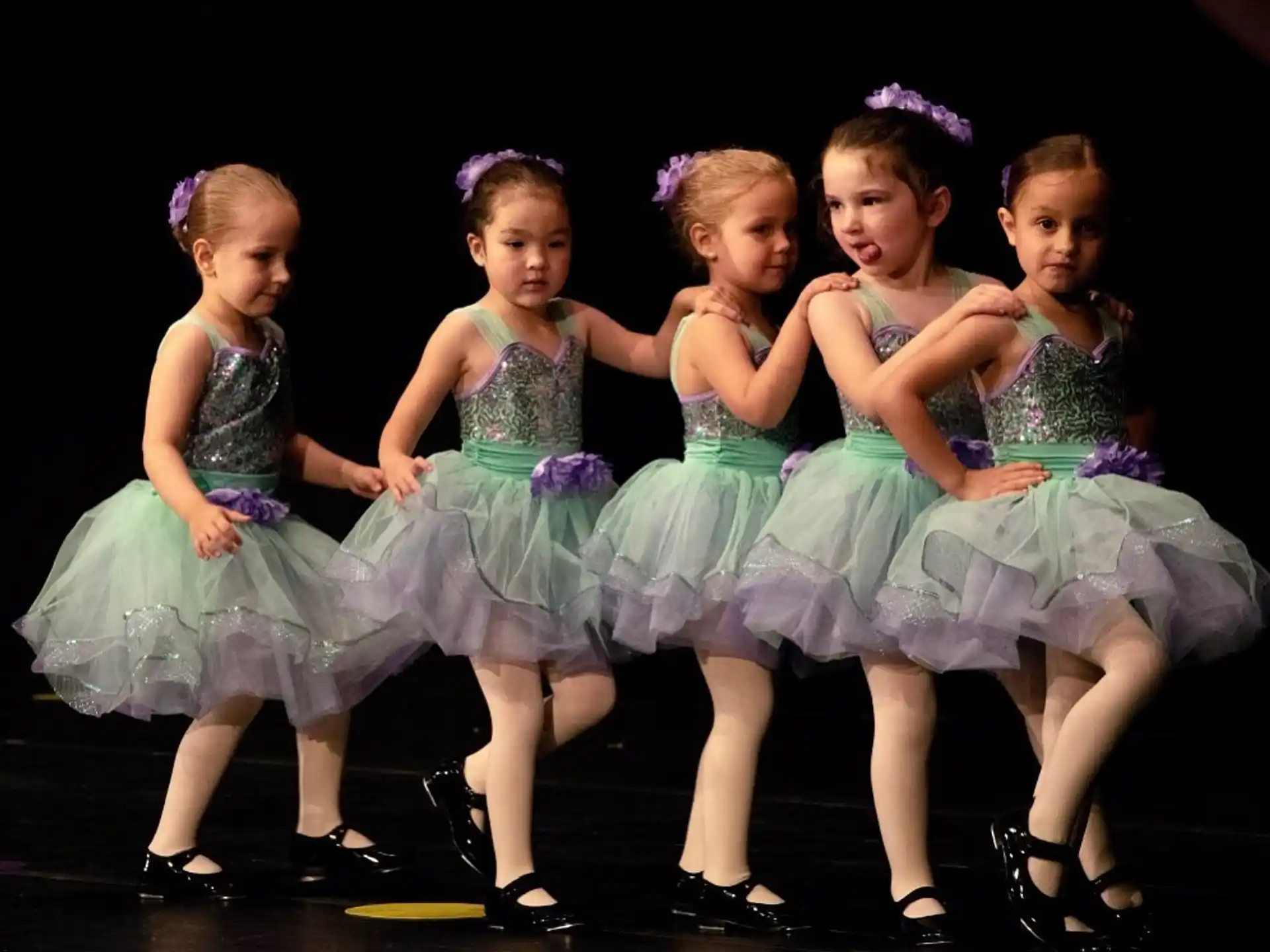 a group of girls in dresses