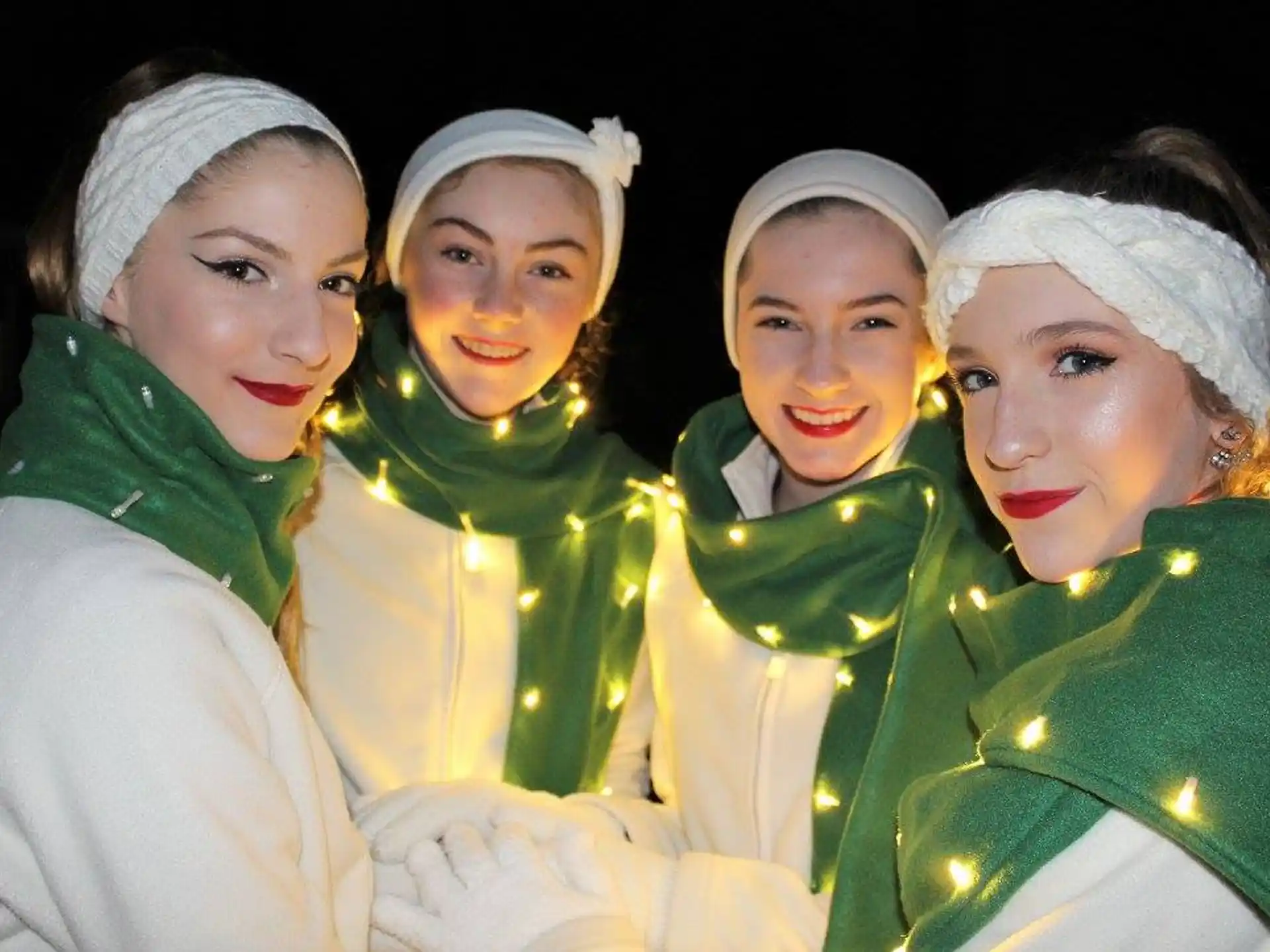 a group of women in white dresses