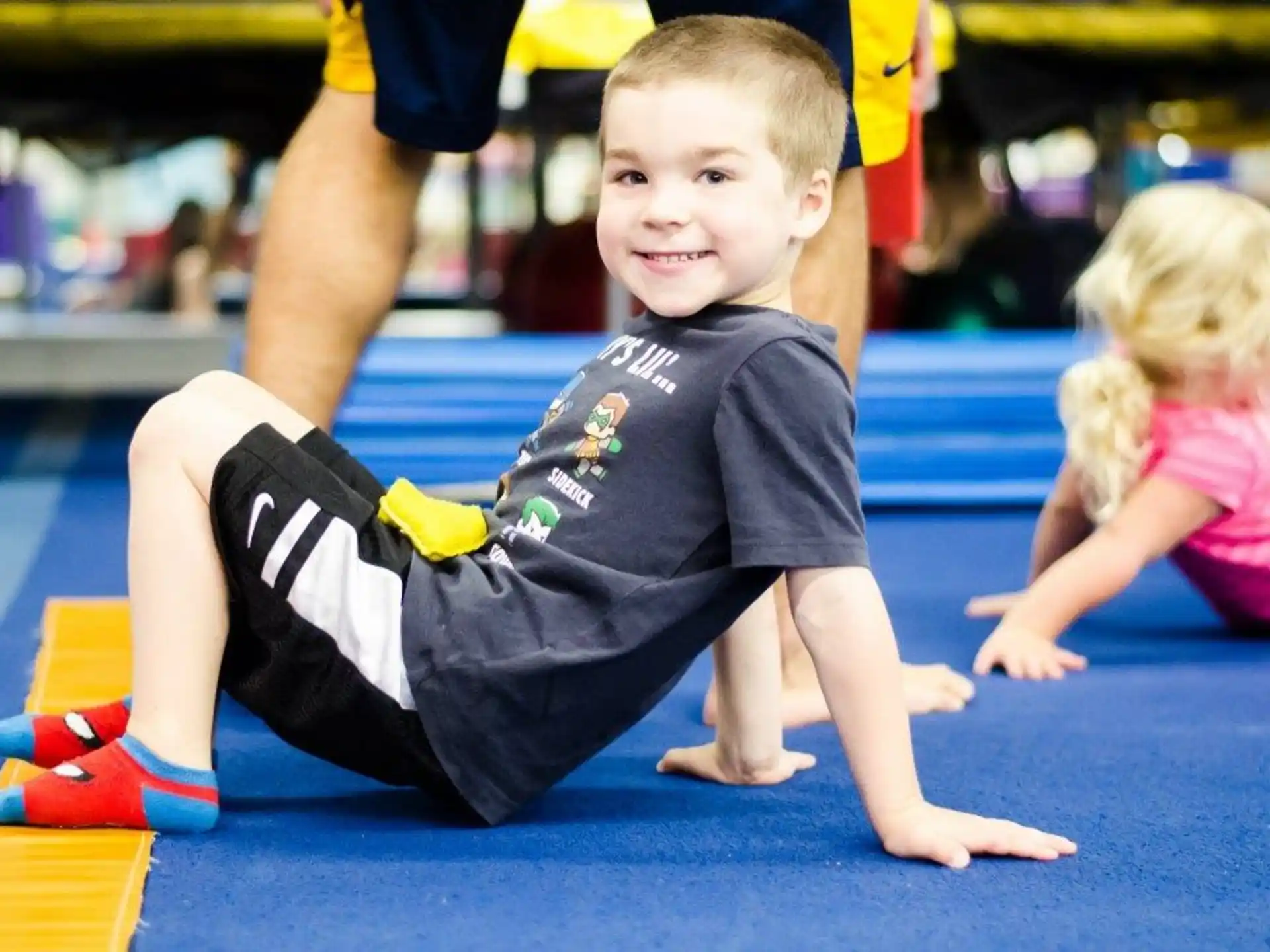 a boy sitting on the floor