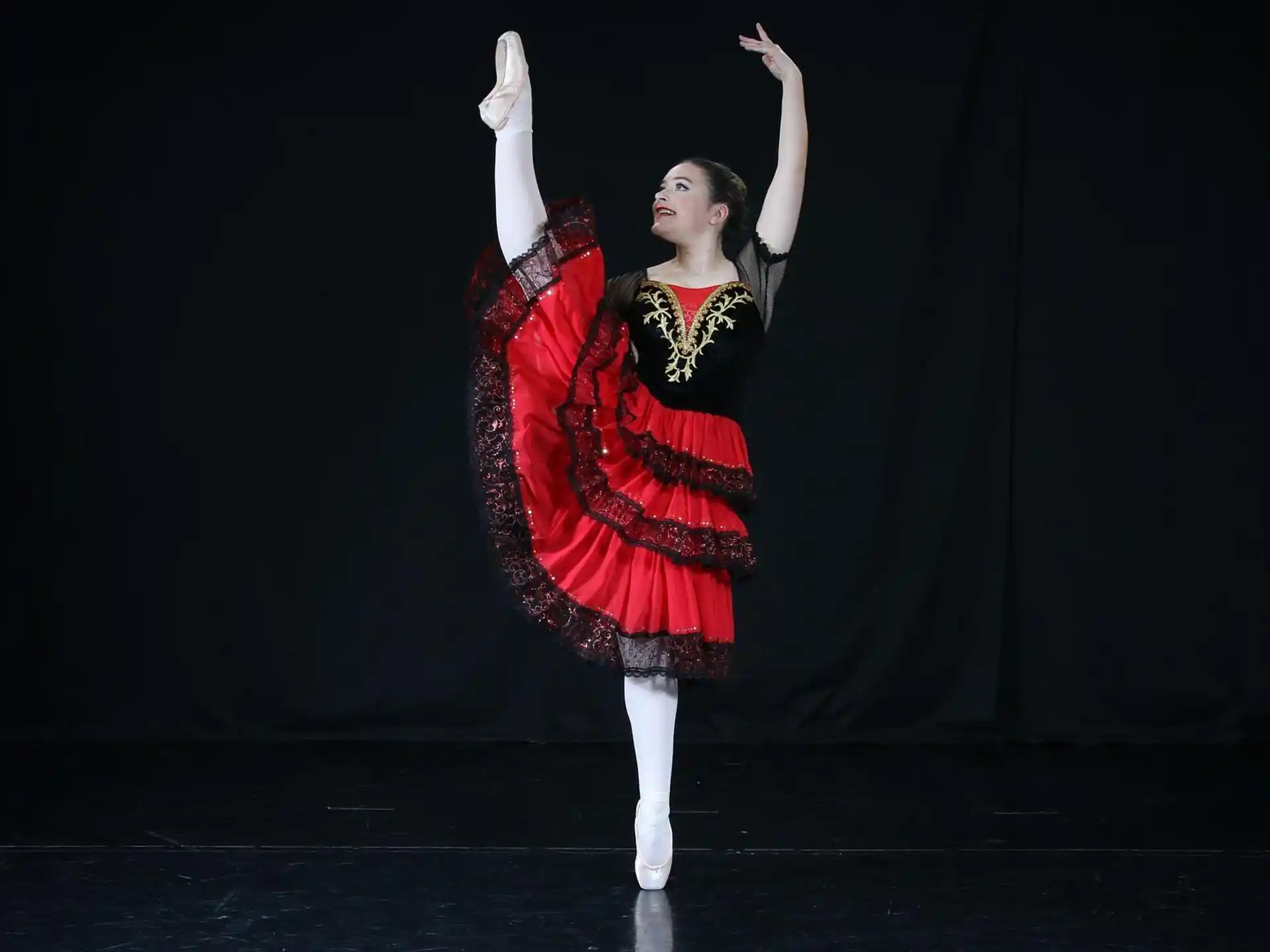 a woman in a red dress dancing