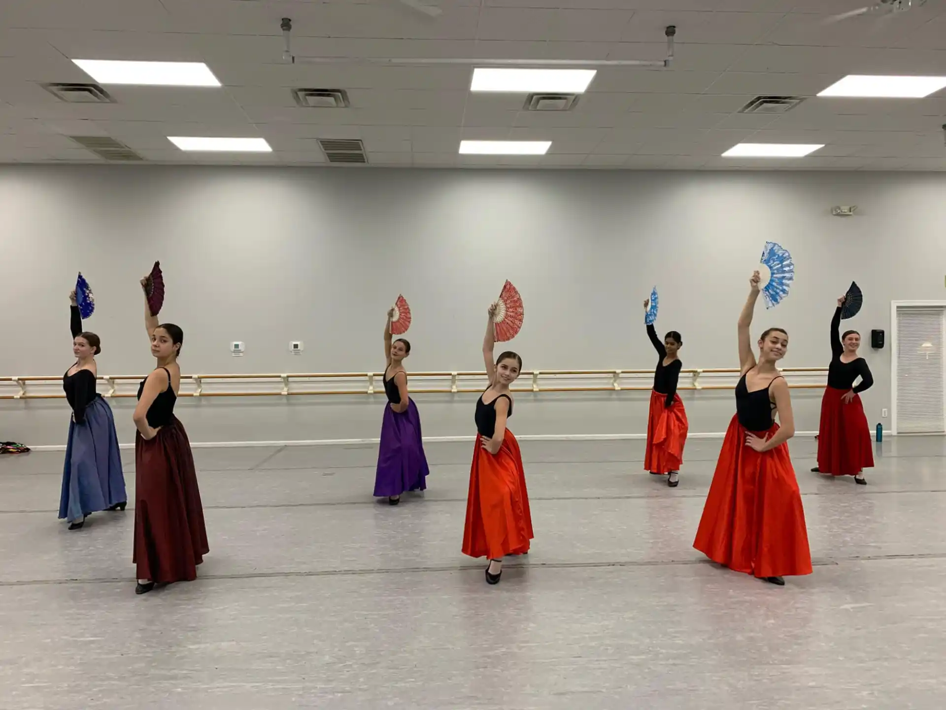 a group of women in dresses dancing