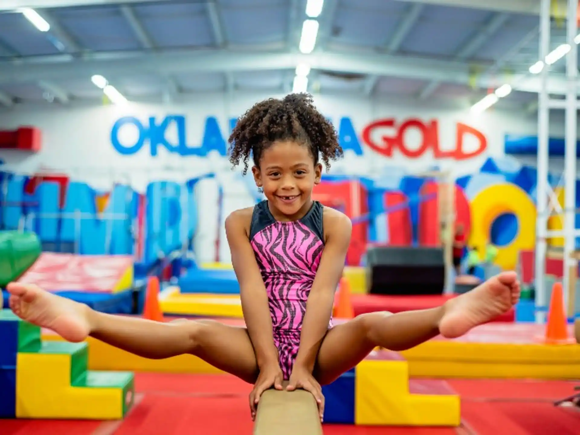 a girl on a mat in a gym