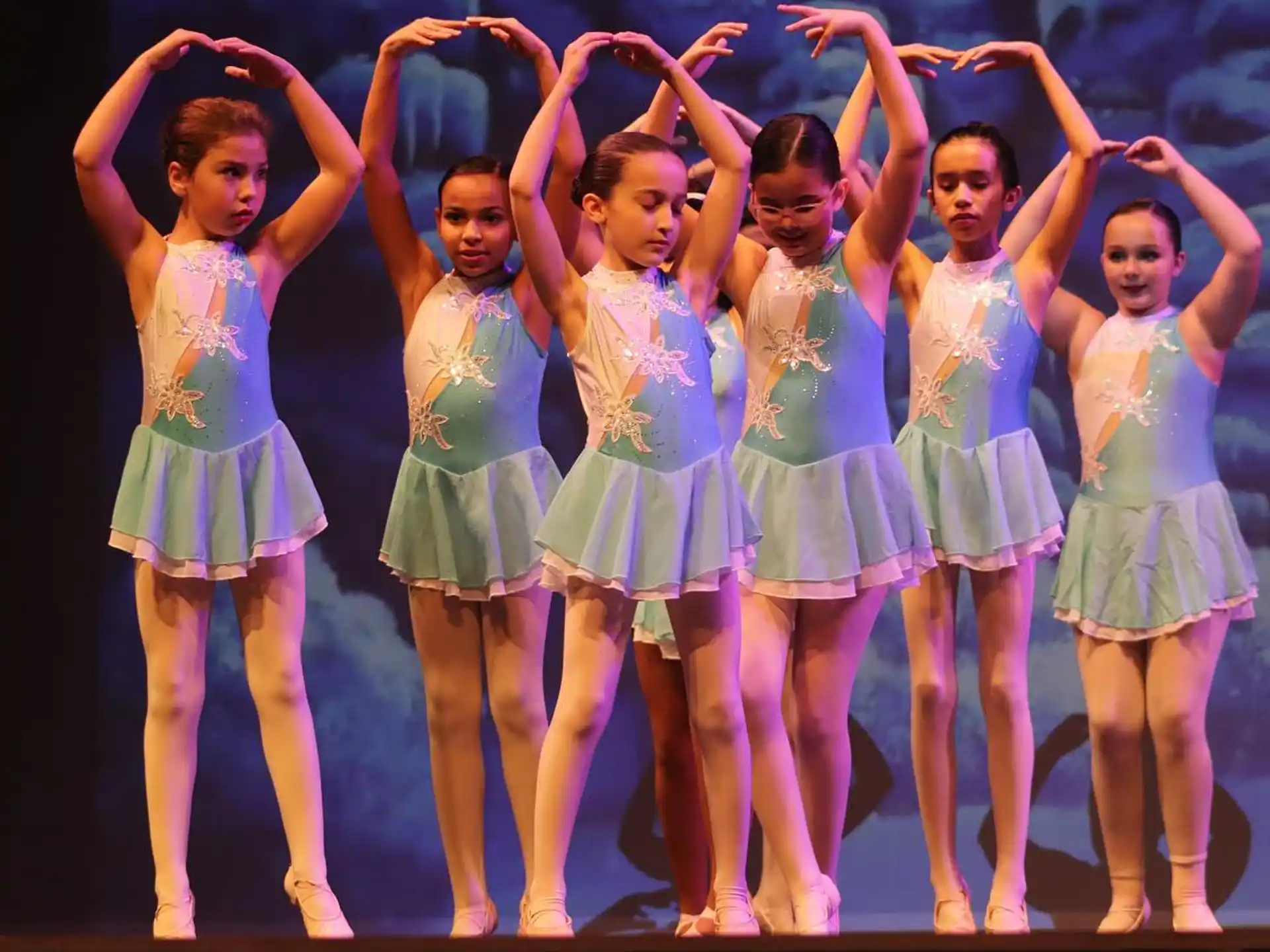 a group of girls in matching outfits