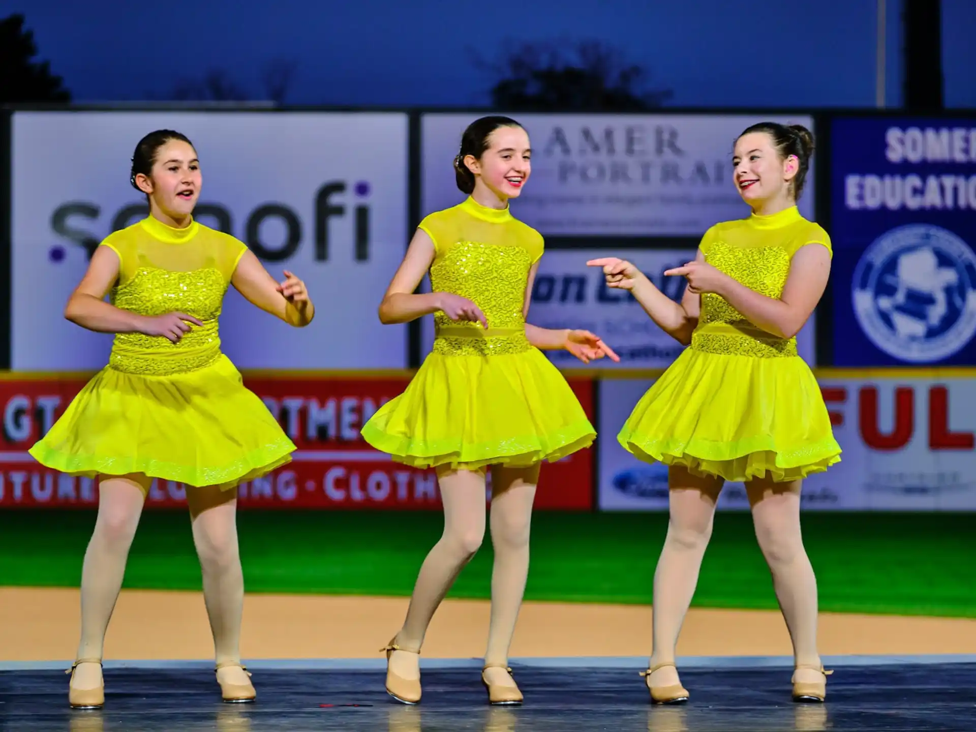 a group of women in yellow dresses