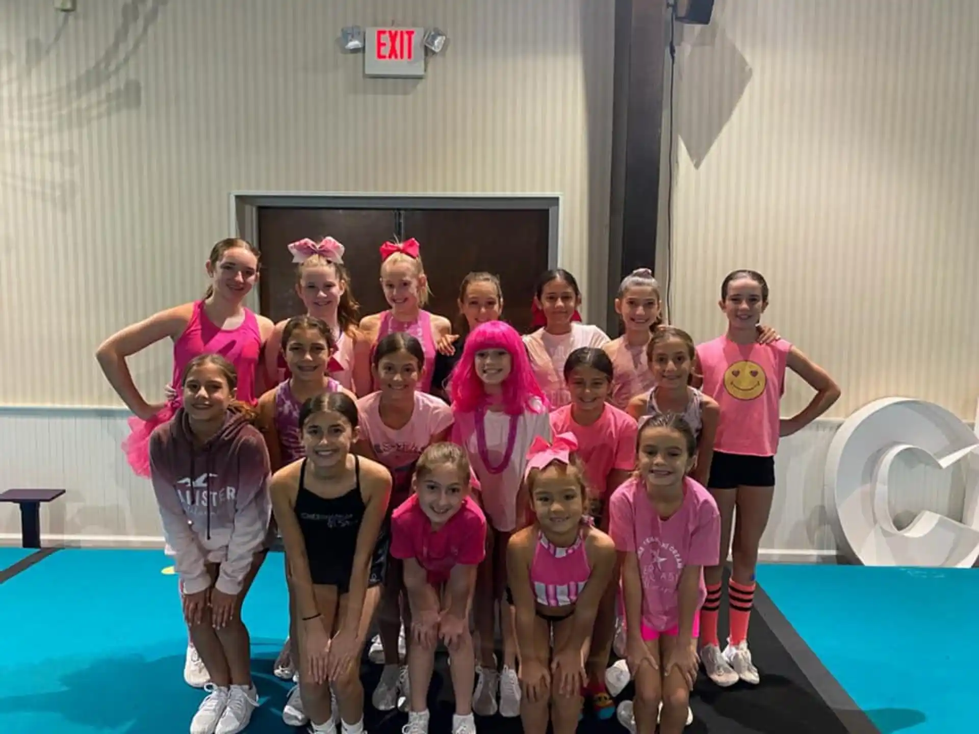 a group of women in pink shirts