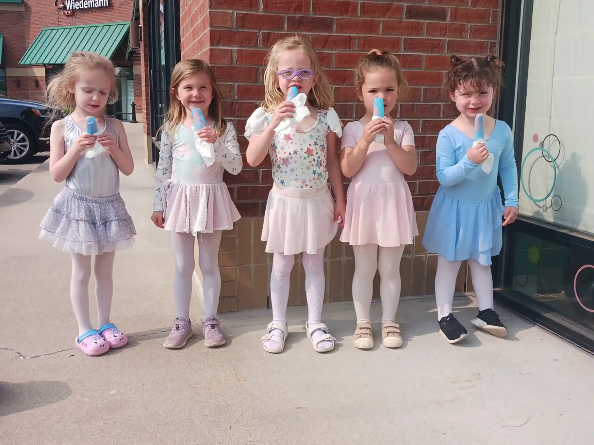 a group of girls in dresses