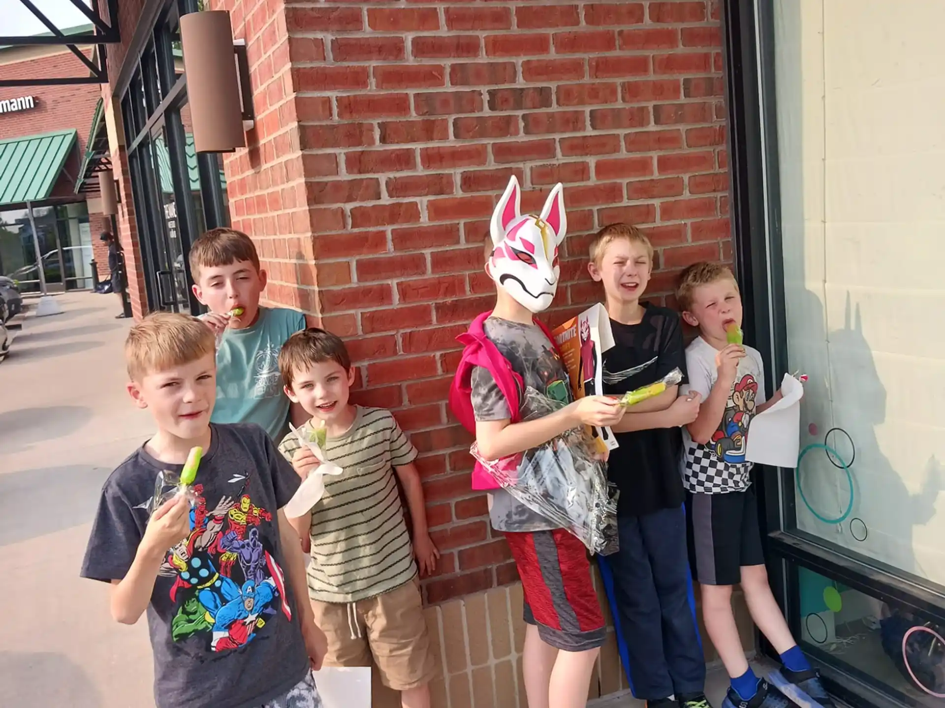 a group of kids standing outside a building
