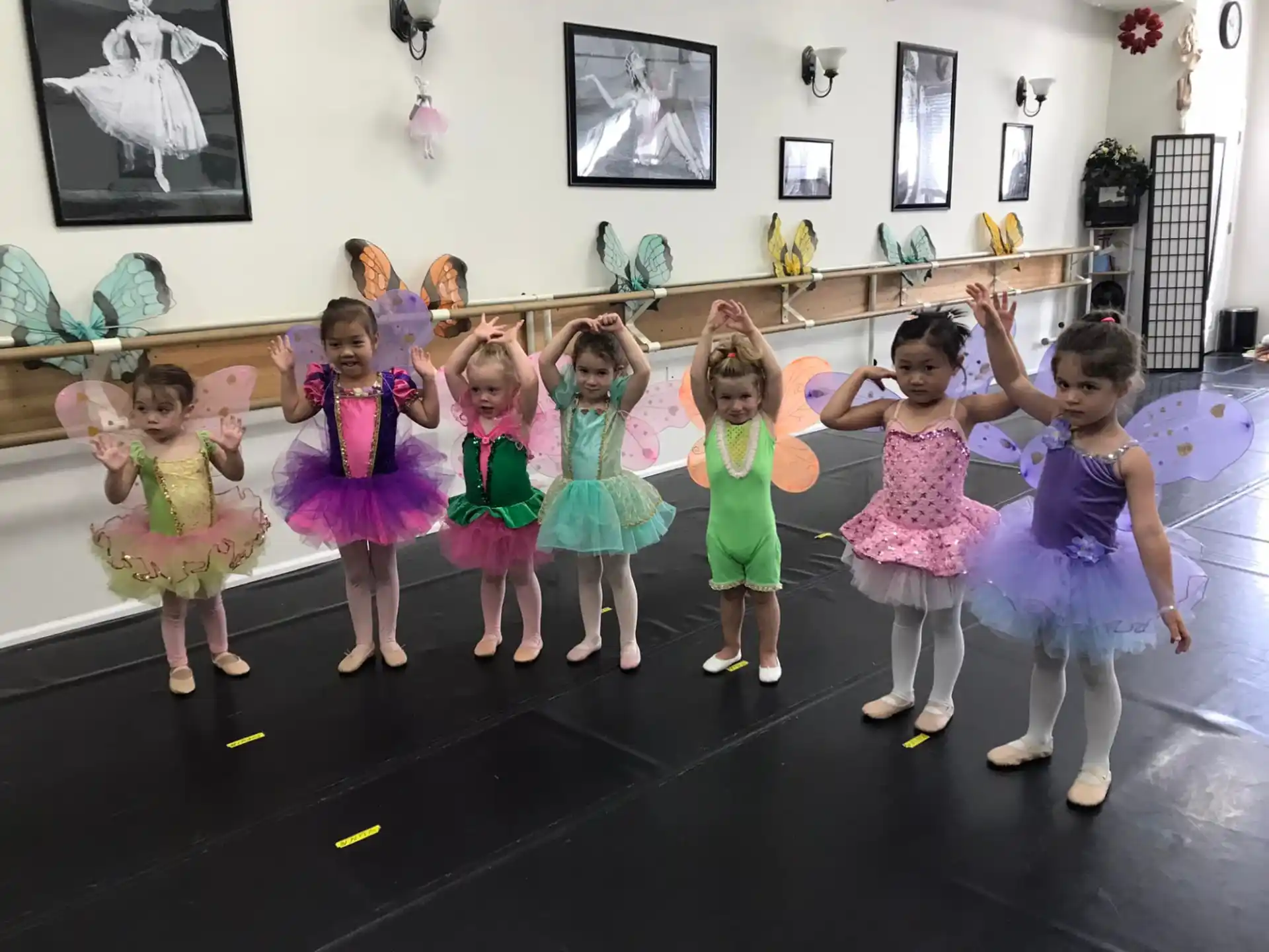 a group of girls in dresses dancing