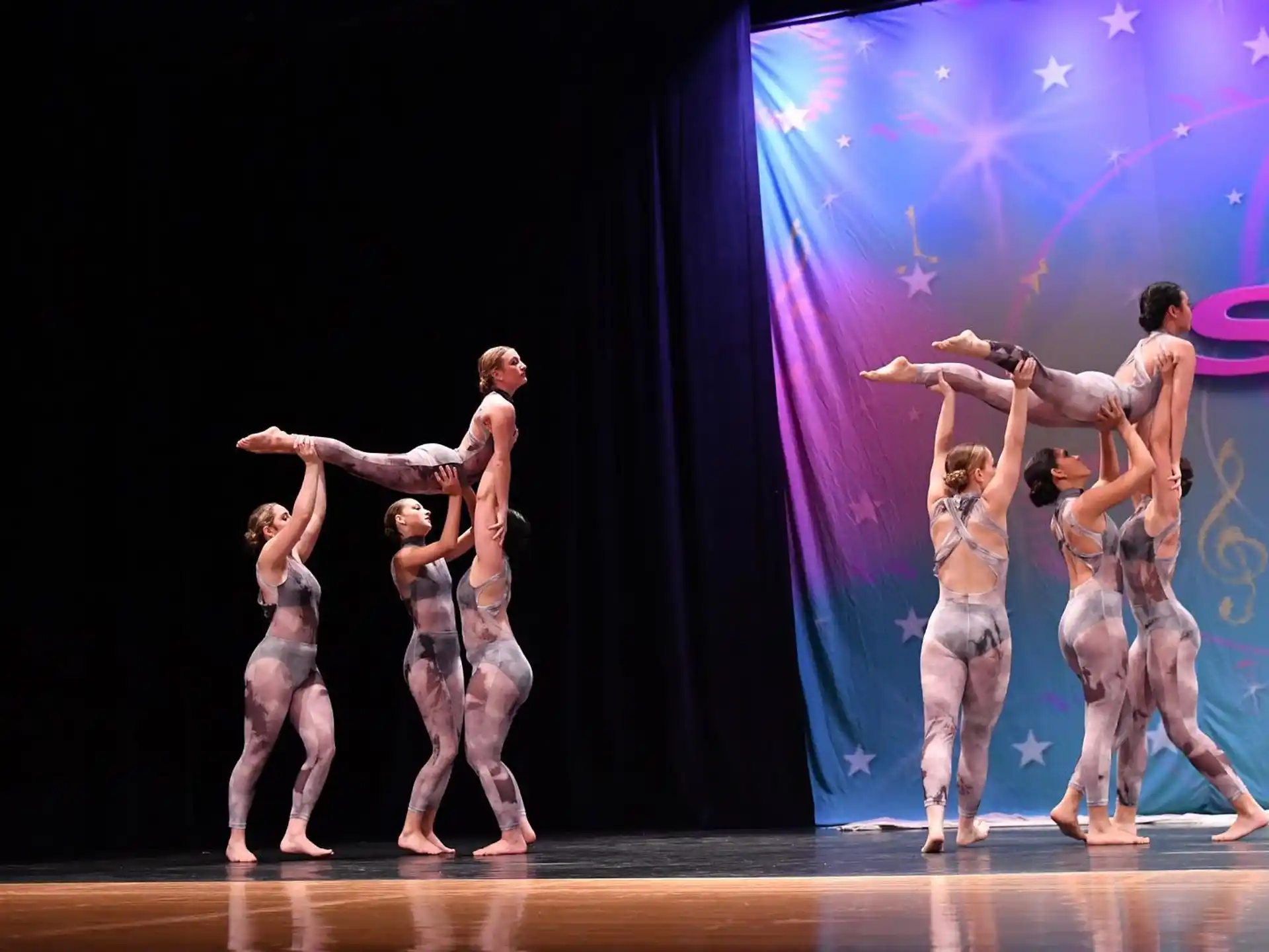 a group of people dancing on a stage