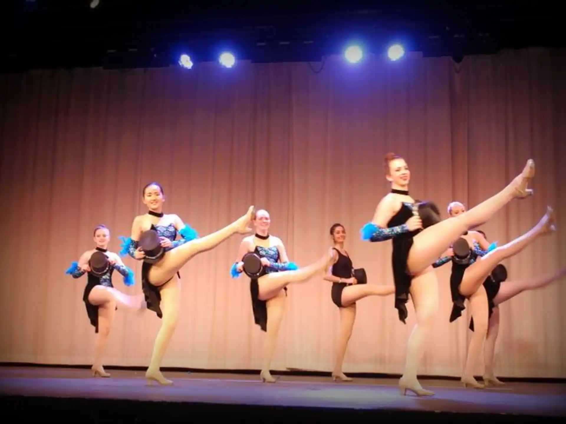 a group of dancers performing on a stage